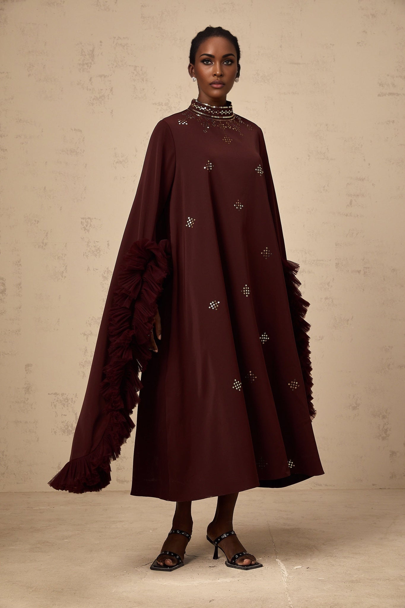 A purple midi dress with sequin embellishments and flared sleeves featuring a design by Anais