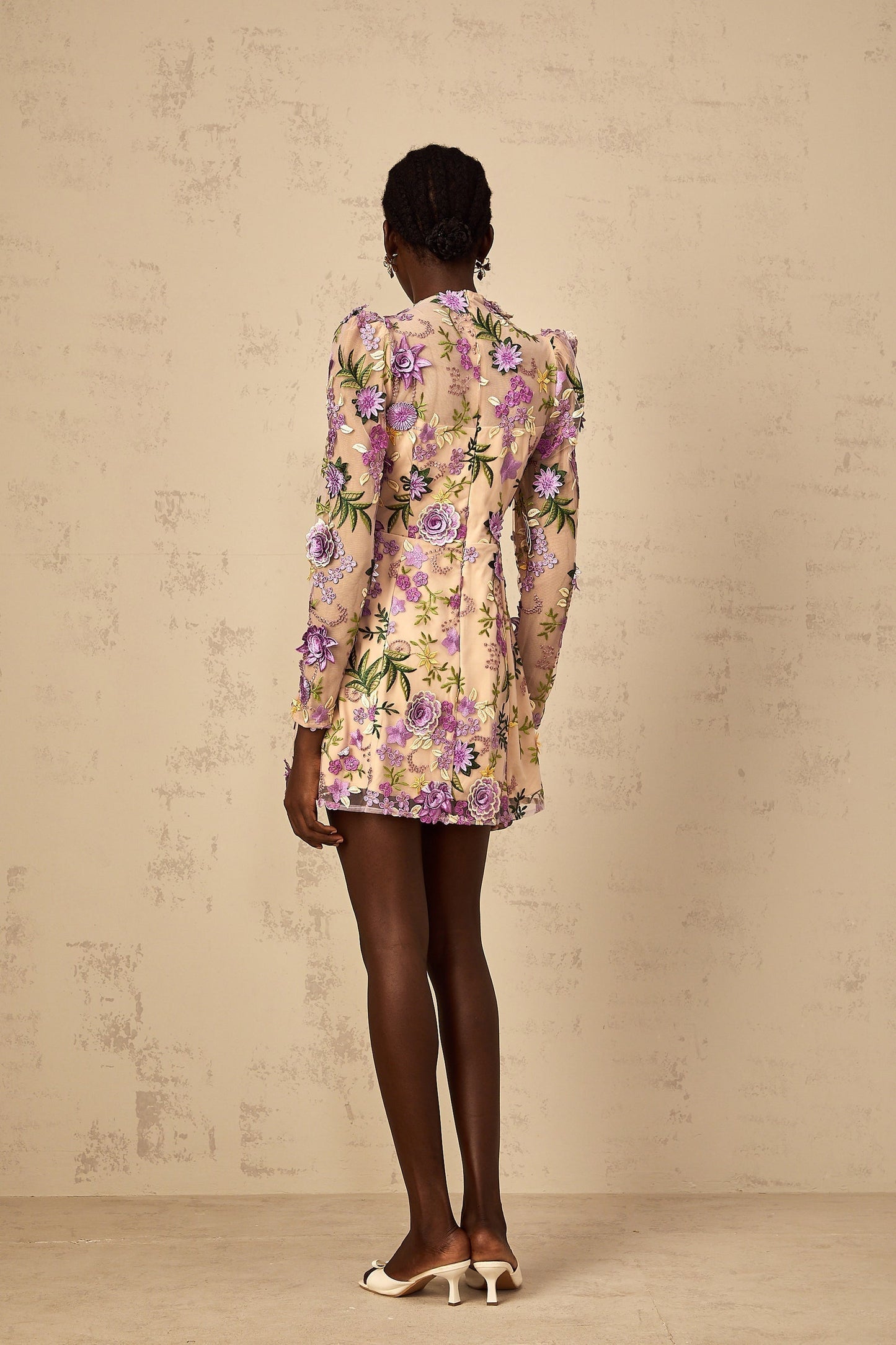 A purple mini dress with floral applique and embroidered tulle details featuring a sleeveless design and a short skirt