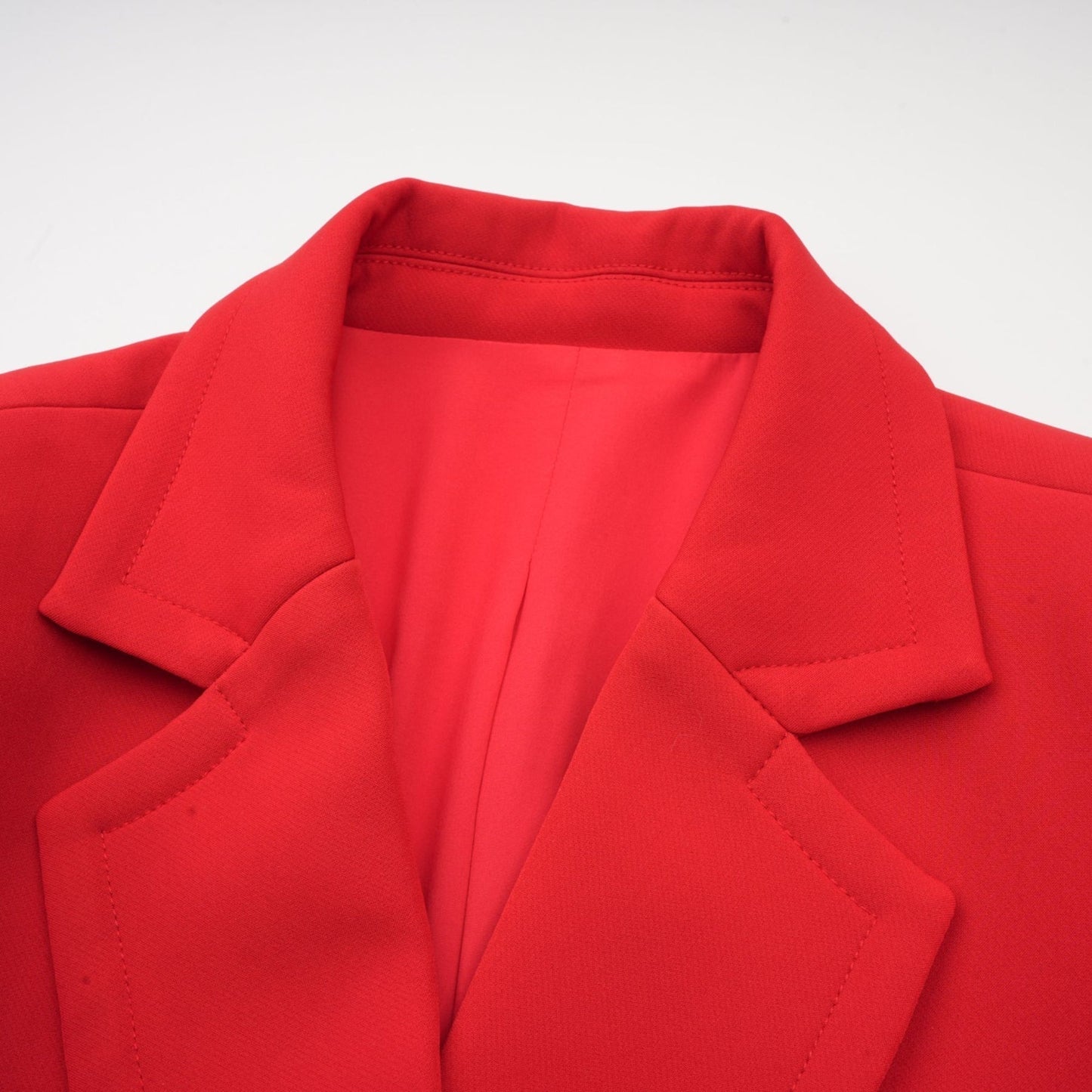 A red blazer with an hourglass silhouette and doublebreasted front closure