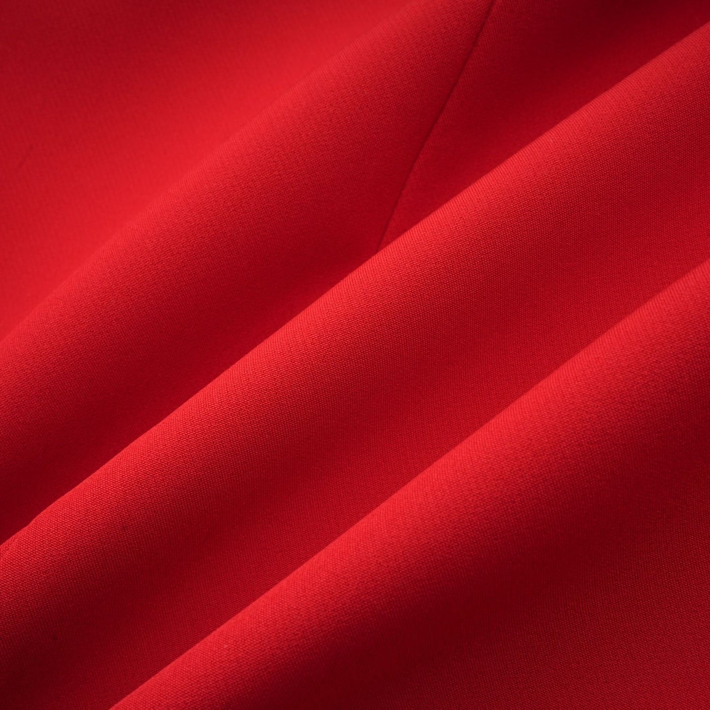 A red blazer with an hourglass silhouette featuring double breasted buttons and a tailored fit