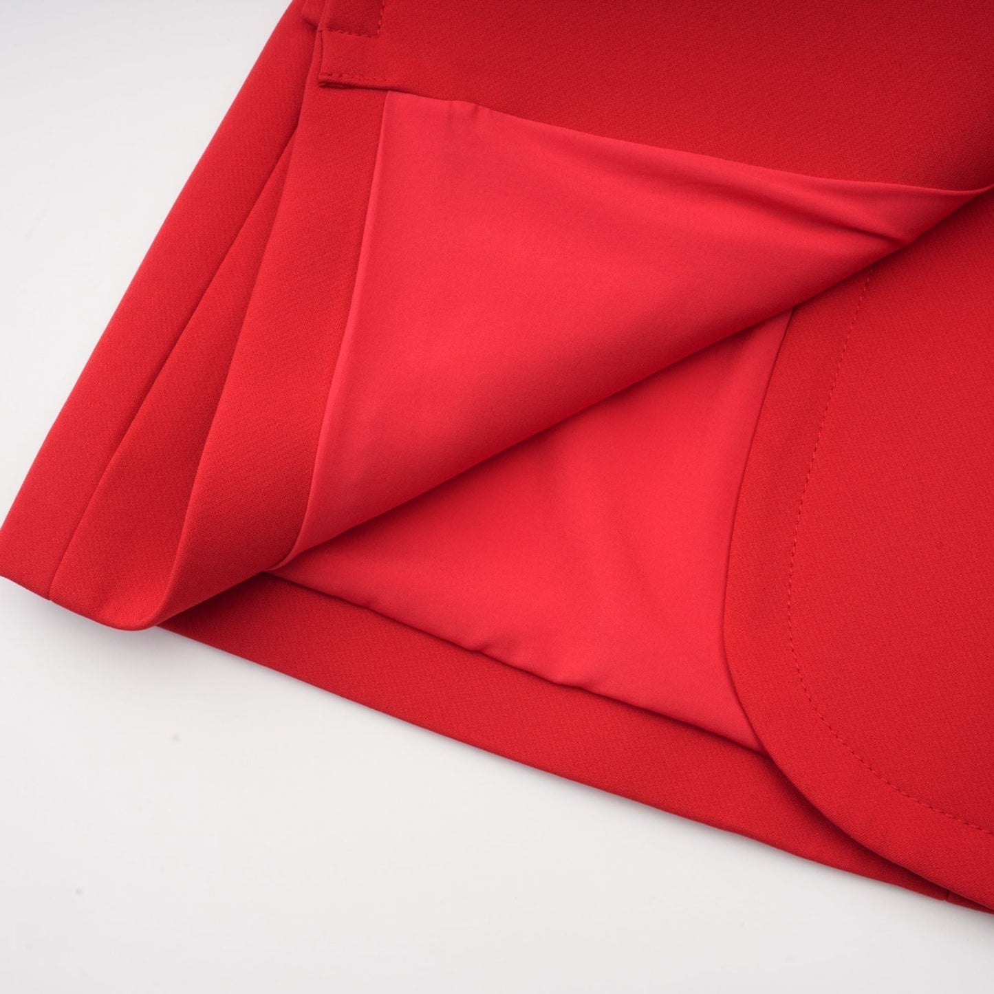 A red blazer with an hourglass silhouette featuring doublebreasted buttons and a tailored fit