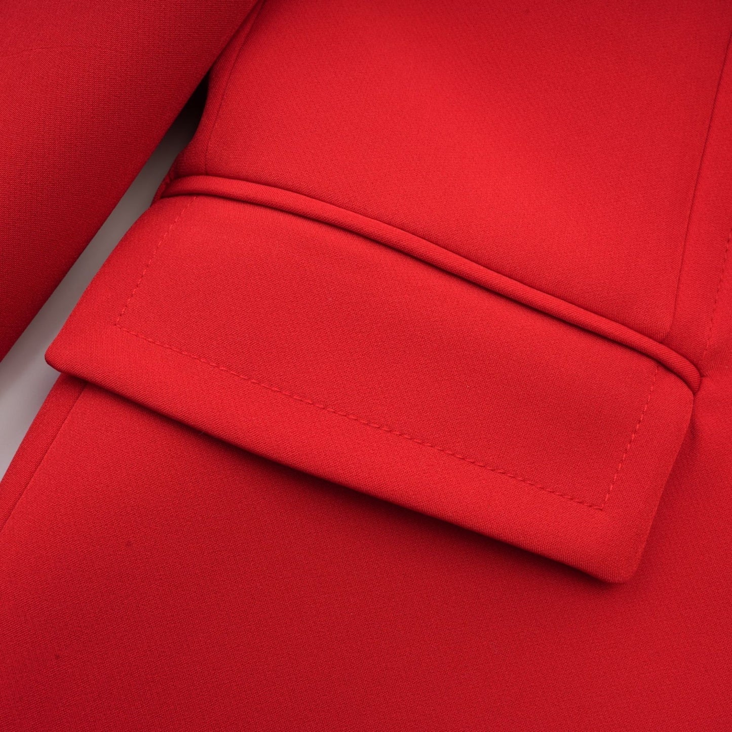 A red blazer with hourglass silhouette and double breasted closure featuring the Coline brand