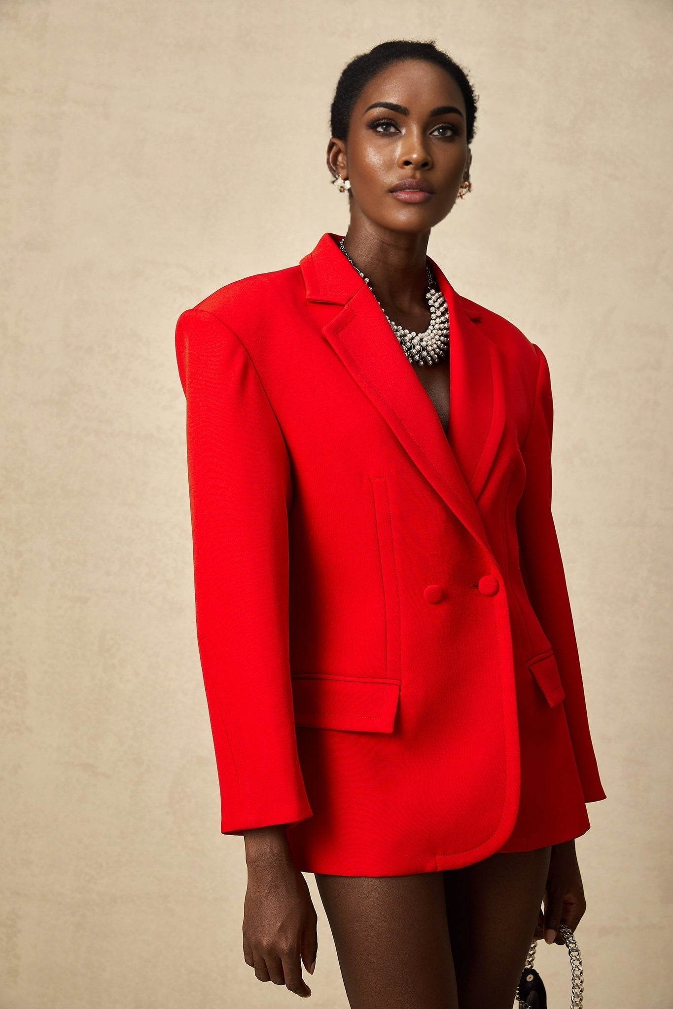 A red blazer with hourglass silhouette and doublebreasted front closure