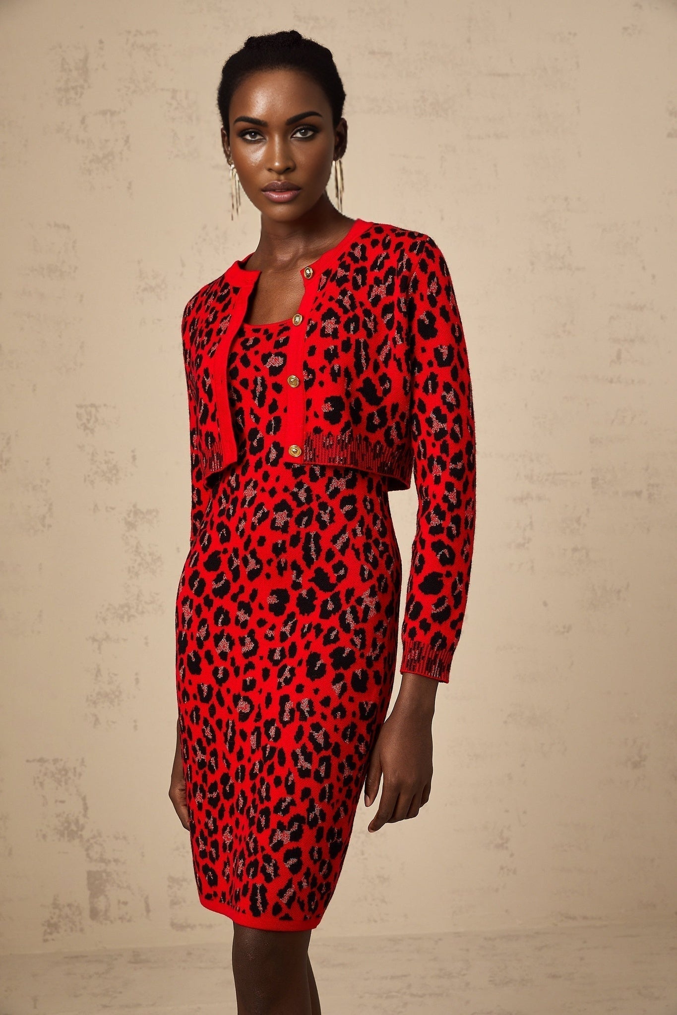A red cardigan with a leopard print pattern made from shimmery lurex fabric