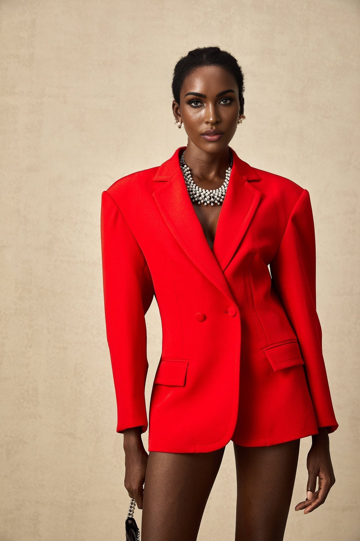 A red doublebreasted blazer with an hourglass silhouette styled in the Coline brand design