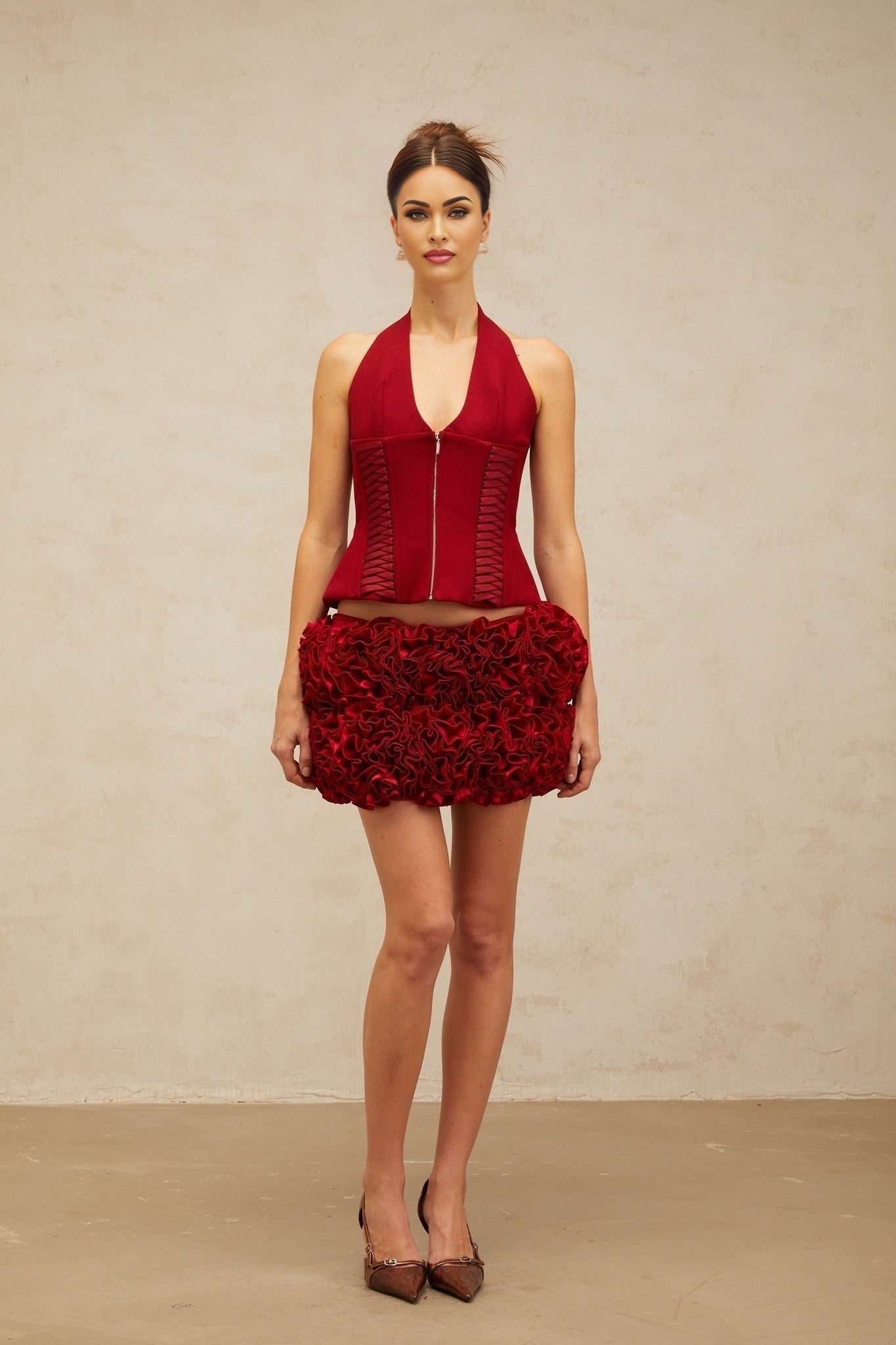 A red halterneck top with laceup detail in the front