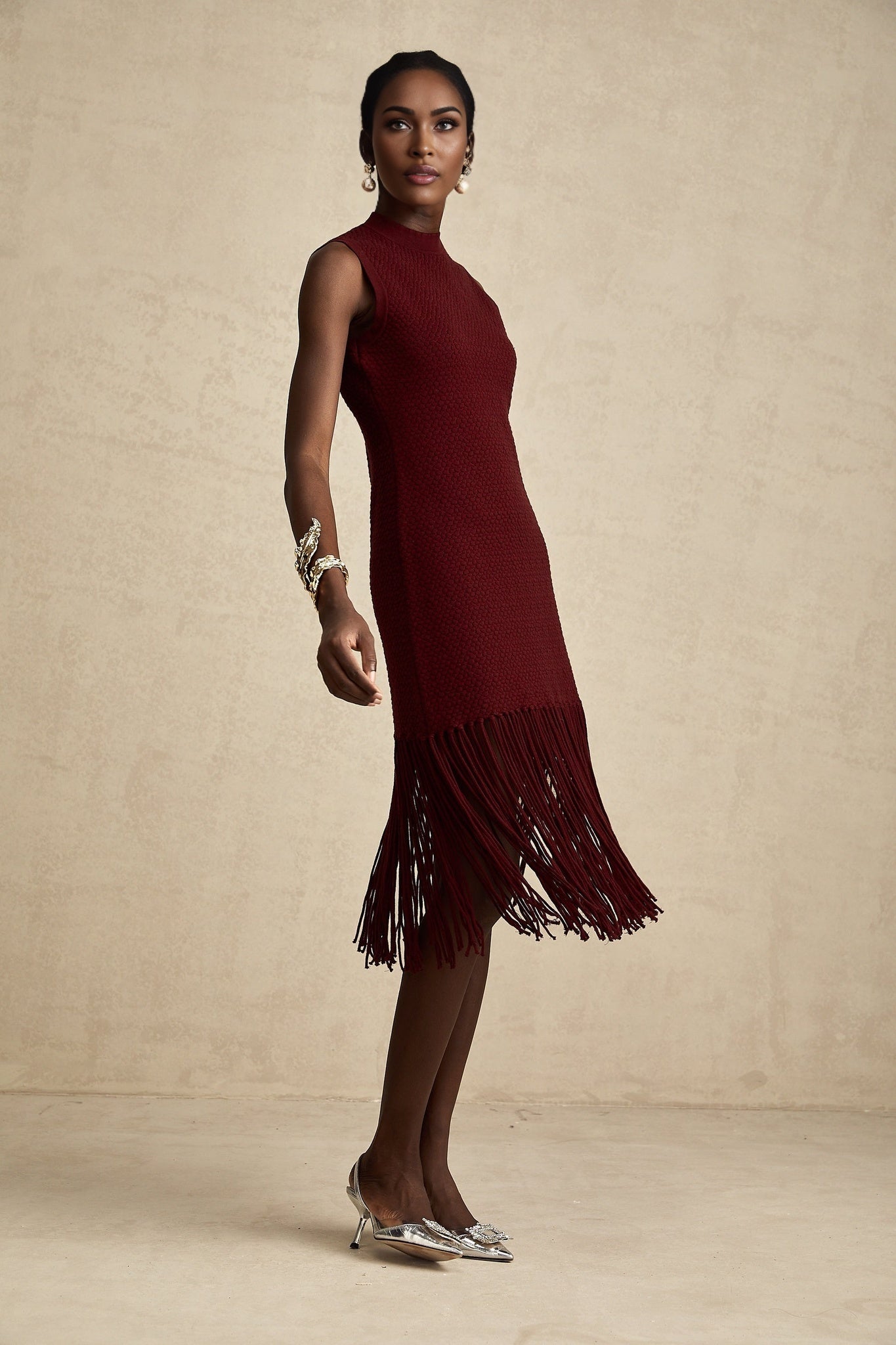 A red knitted midi dress by Celine featuring fringe details