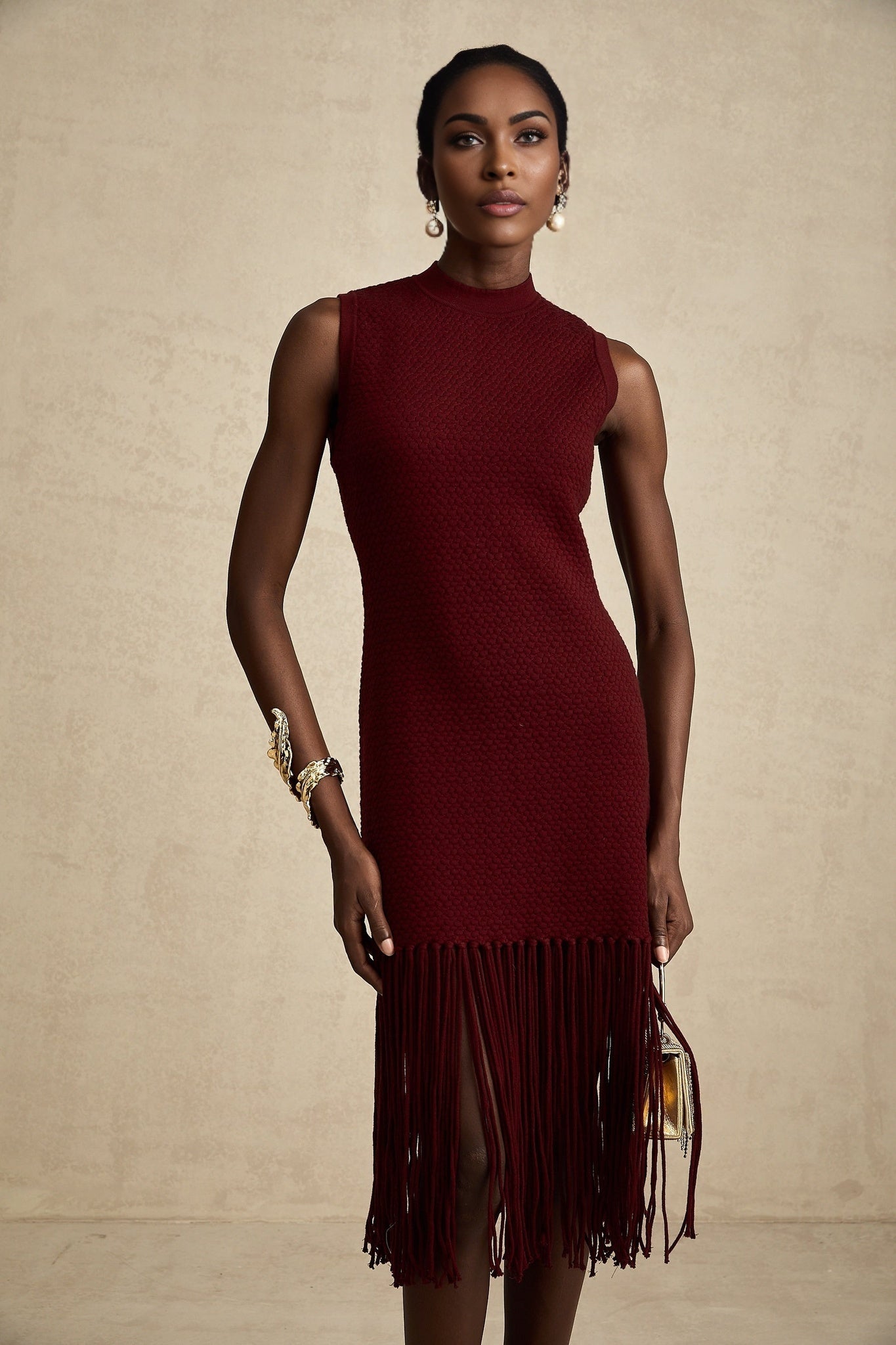 A red knitted midi dress by Celine featuring fringe details