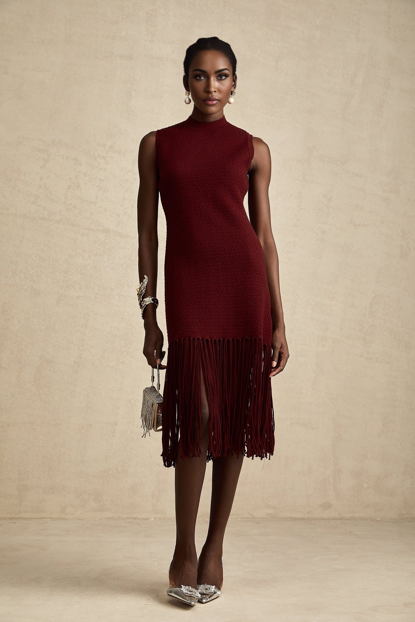 A red knitted midi dress by Celine with fringe details