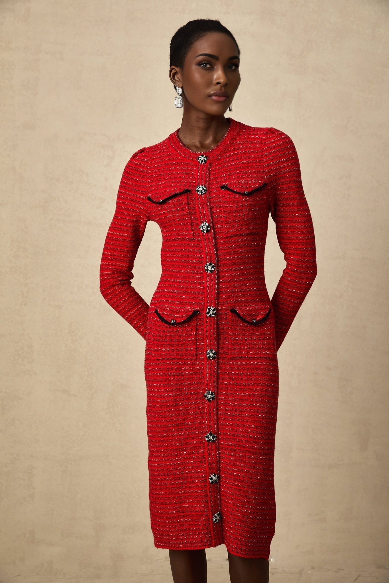 A red knitted midi dress with embellishments named Faustine featuring a fitted silhouette and decorative details on the fabric