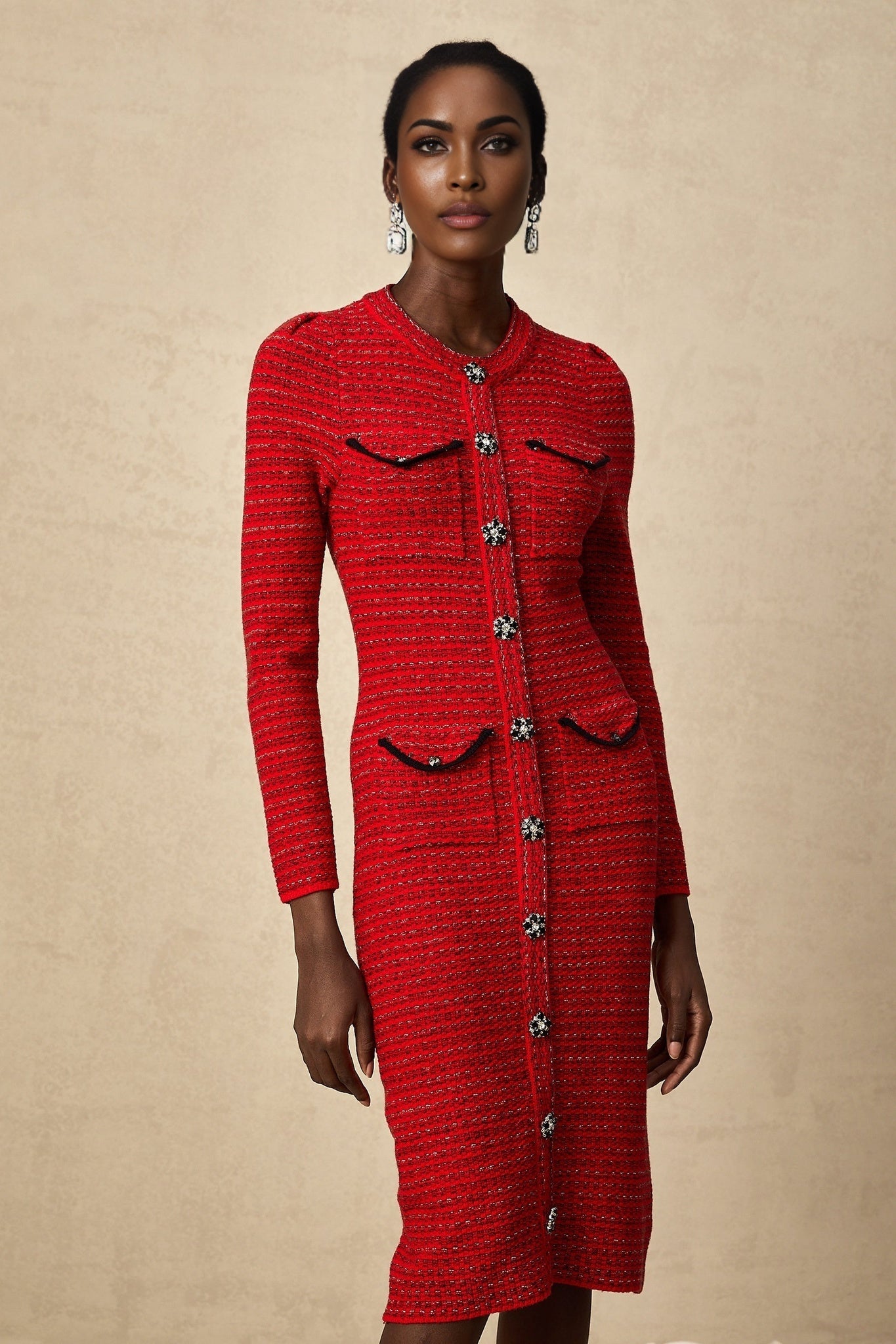 A red knitted midi dress with embellishments named Faustine on a plain background