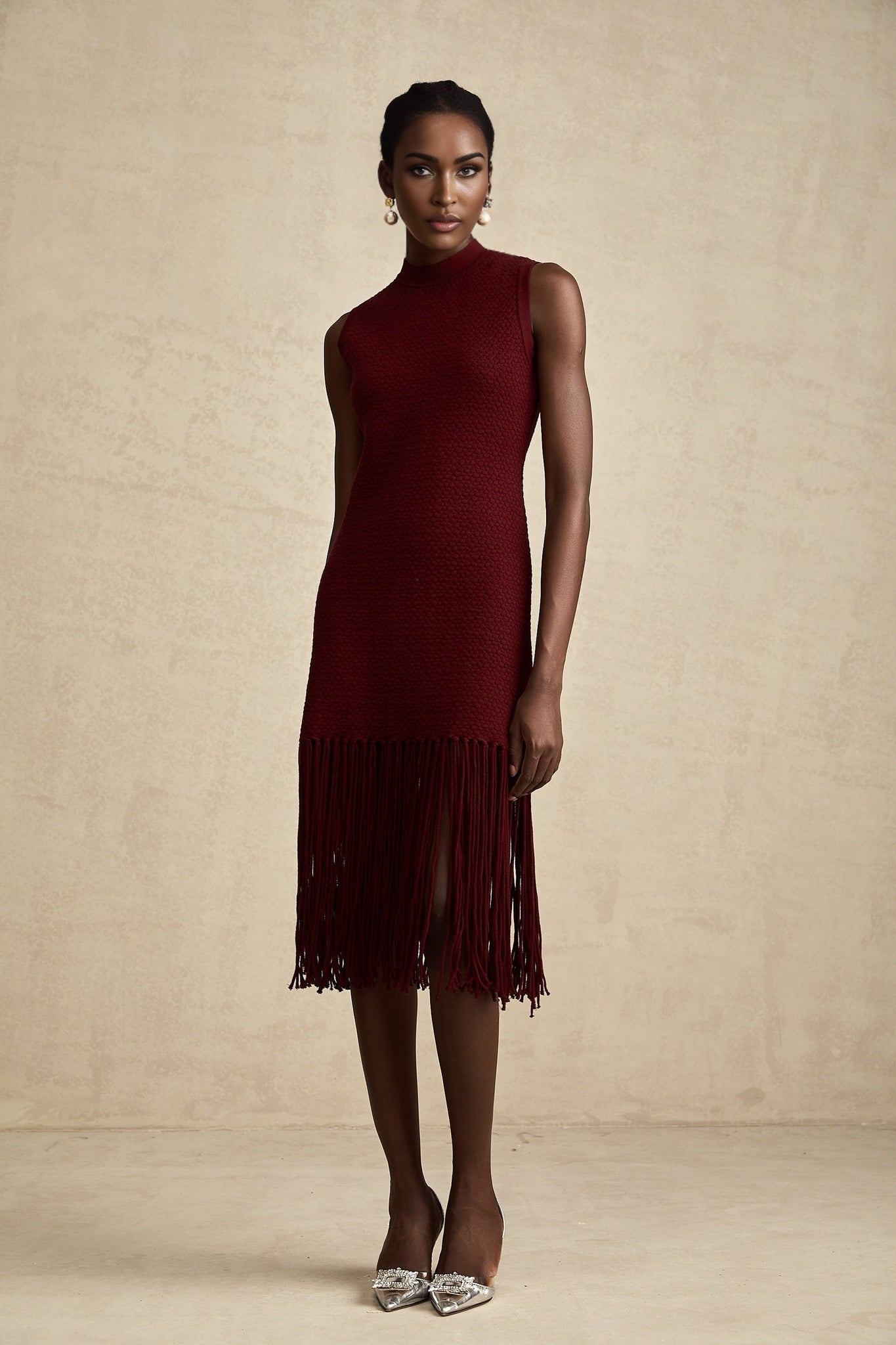 A red knitted midi dress with fringe details by Celine