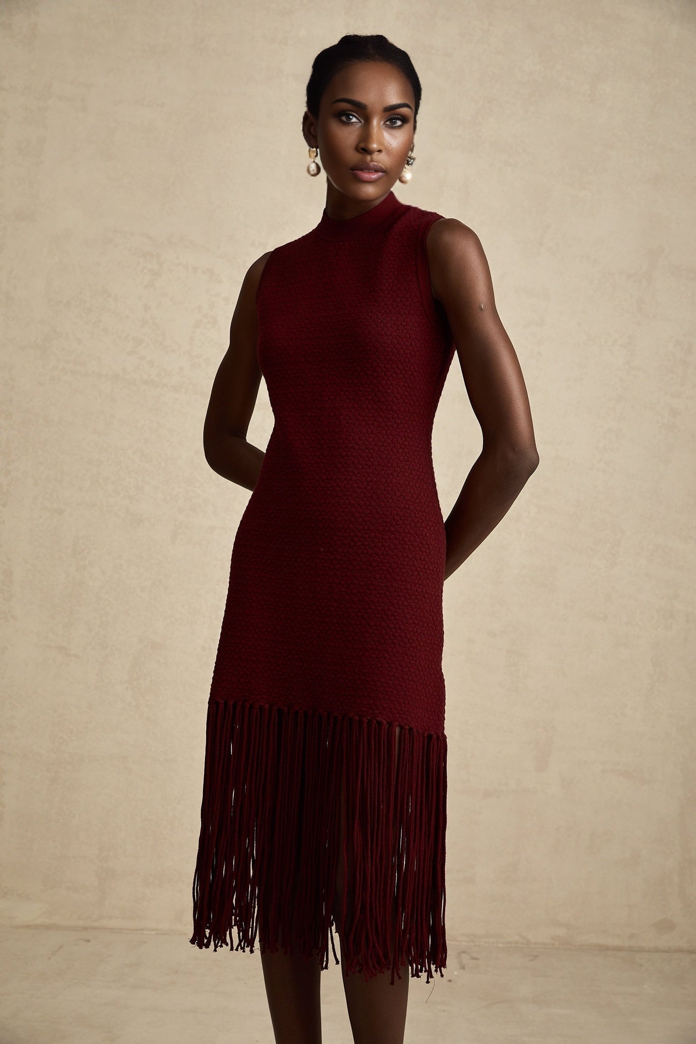 A red knitted midi dress with fringe details designed by Celine