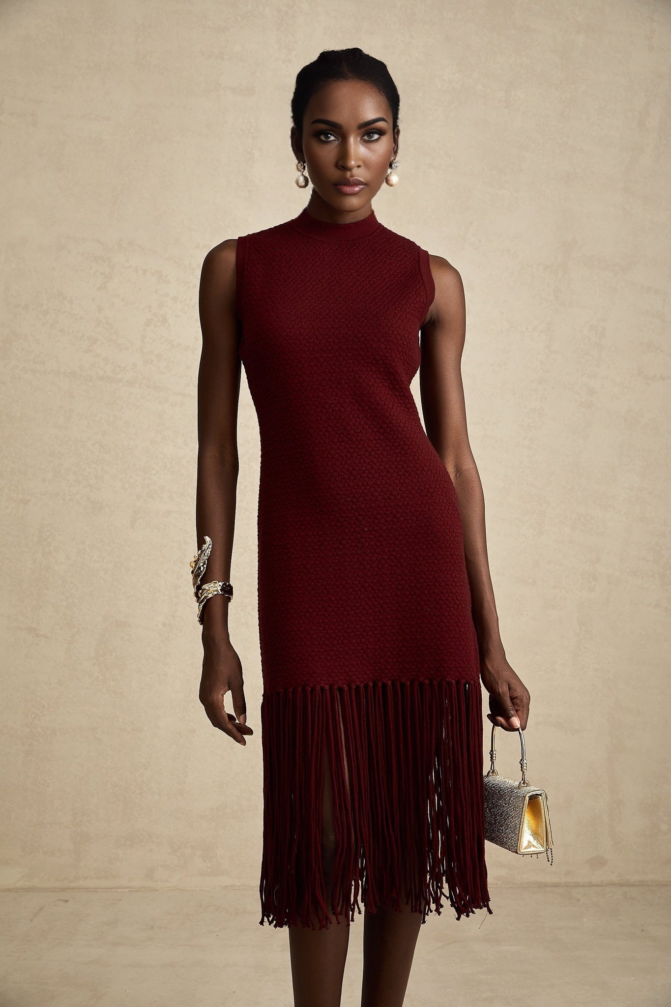 A red knitted midi dress with fringe details designed by Celine
