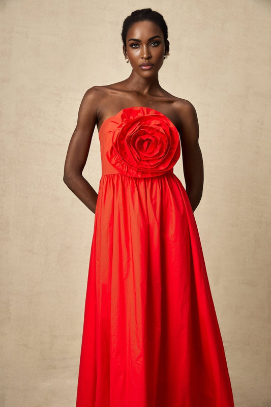A red maxi dress with 3d petal ruffles covering the bodice and skirt creating a dramatic floral effect