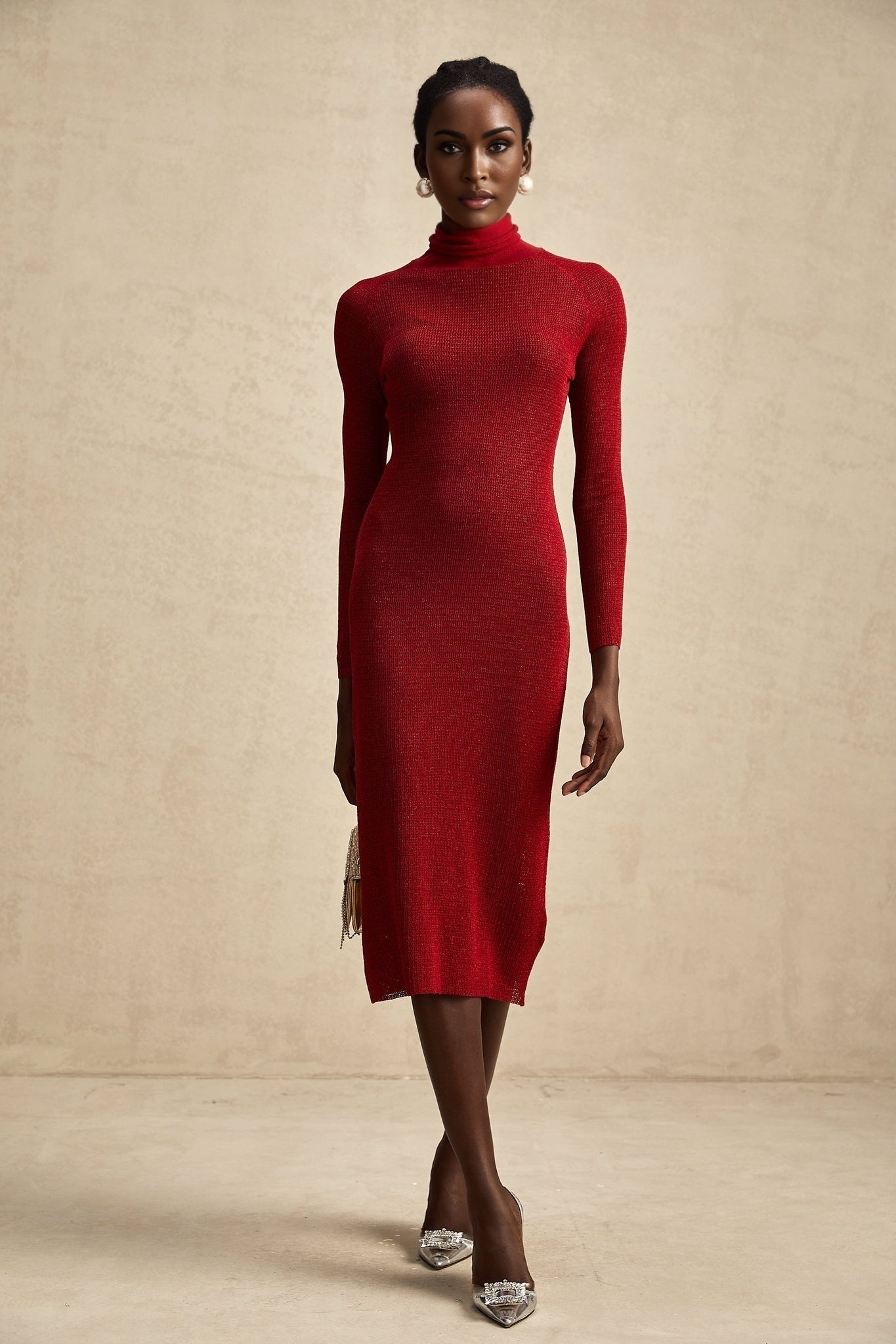 A red metallic midi dress with a pointelle knit pattern featuring a fitted silhouette and shimmering fabric