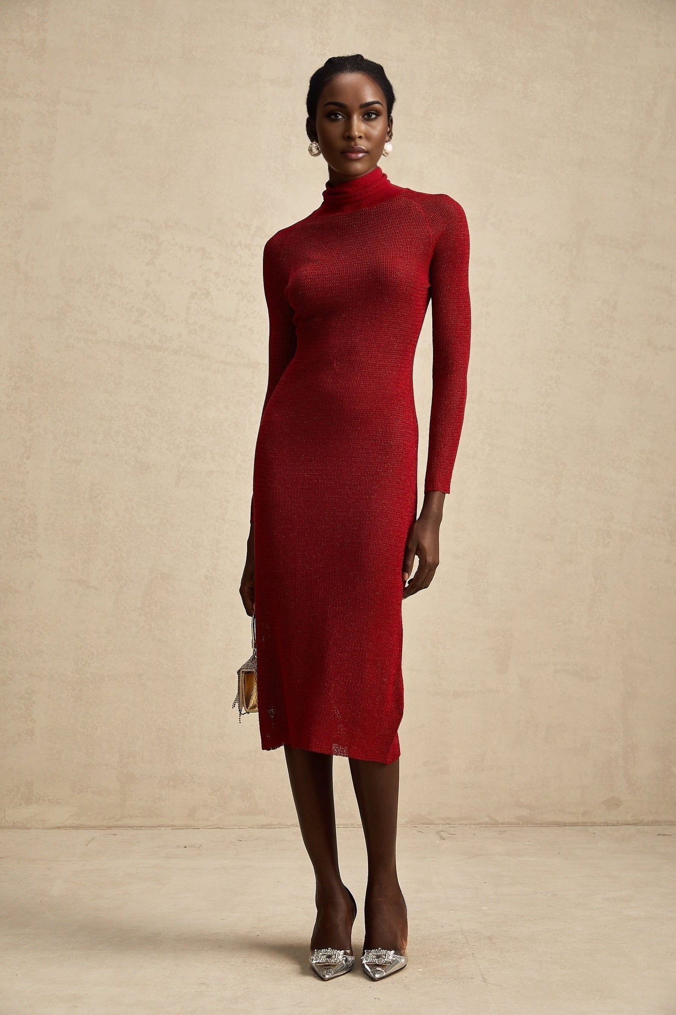 A red metallic midi dress with pointelle knit detailing and a formfitting silhouette