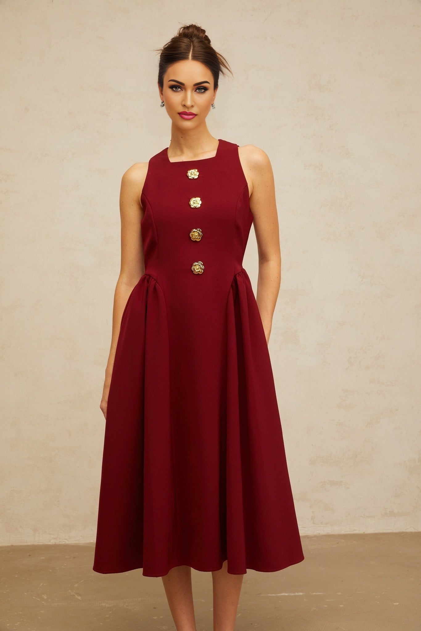 A red midi tank dress with a floral motif pattern featuring pleats and a flowing skirt named Amandine