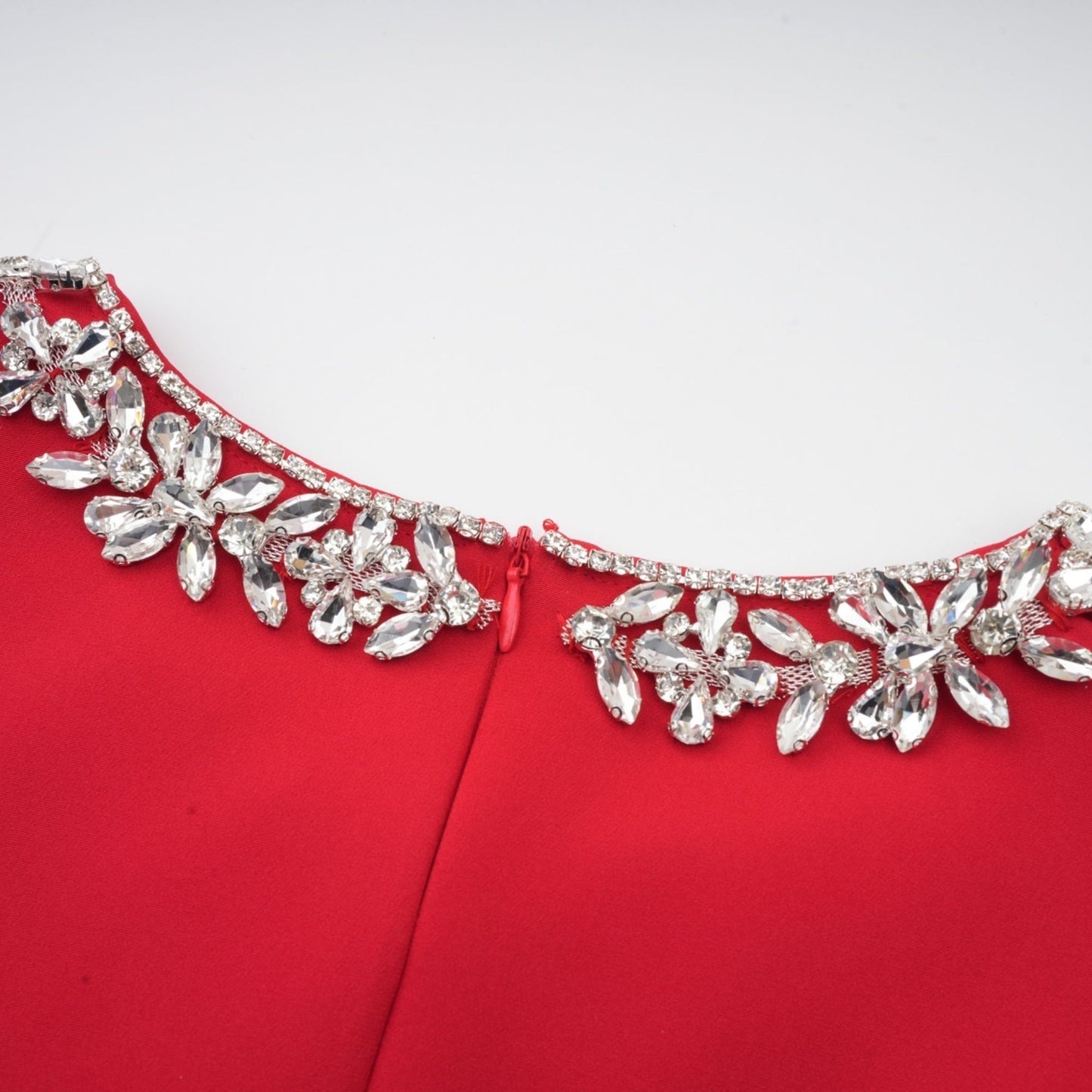 A red mini dress with pleated details and embellishments named Leonie