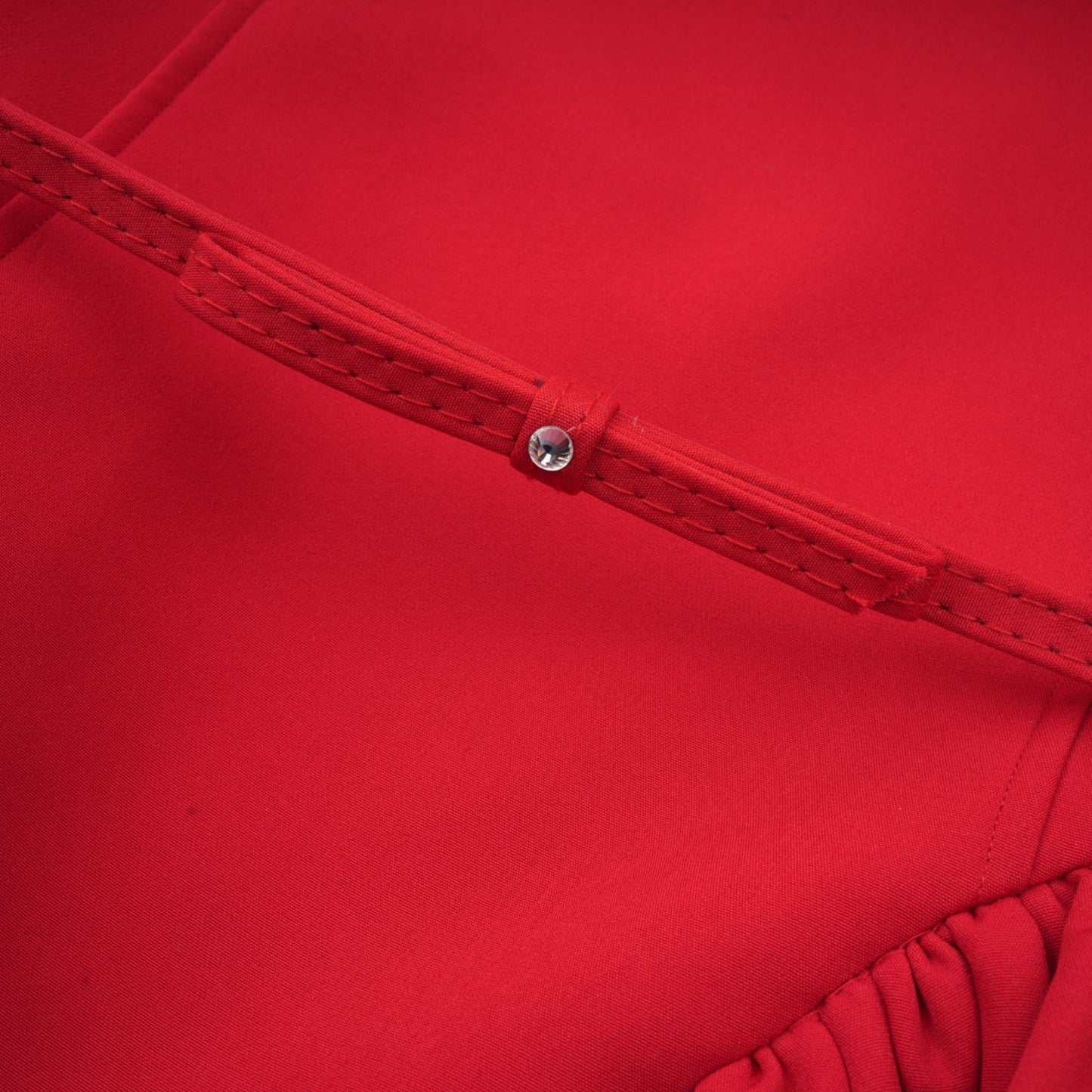 A red mini dress with pleated details and embellishments named Leonie