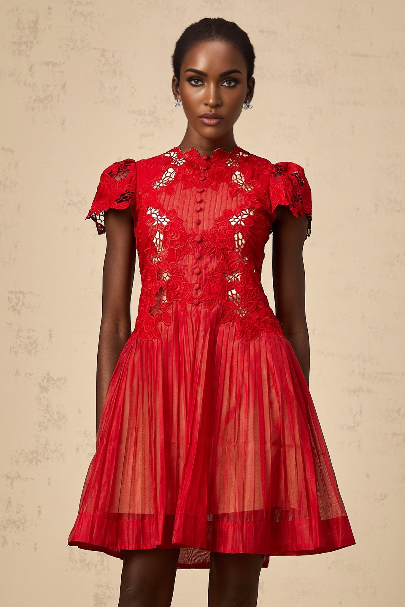 A red mini dress with pleated fabric and floral embroidery featuring a feminine silhouette and short length