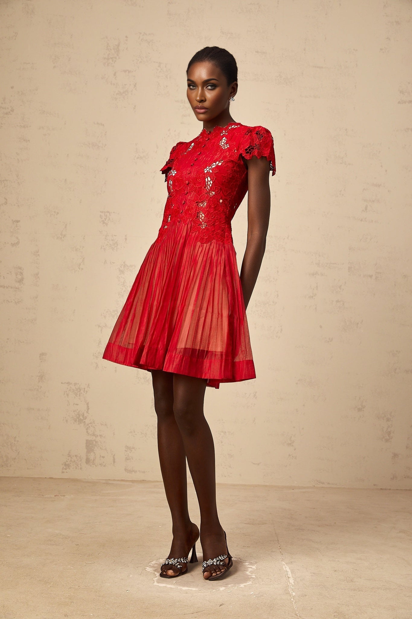 A red mini dress with pleated skirt and floral embroidery details named Corinne