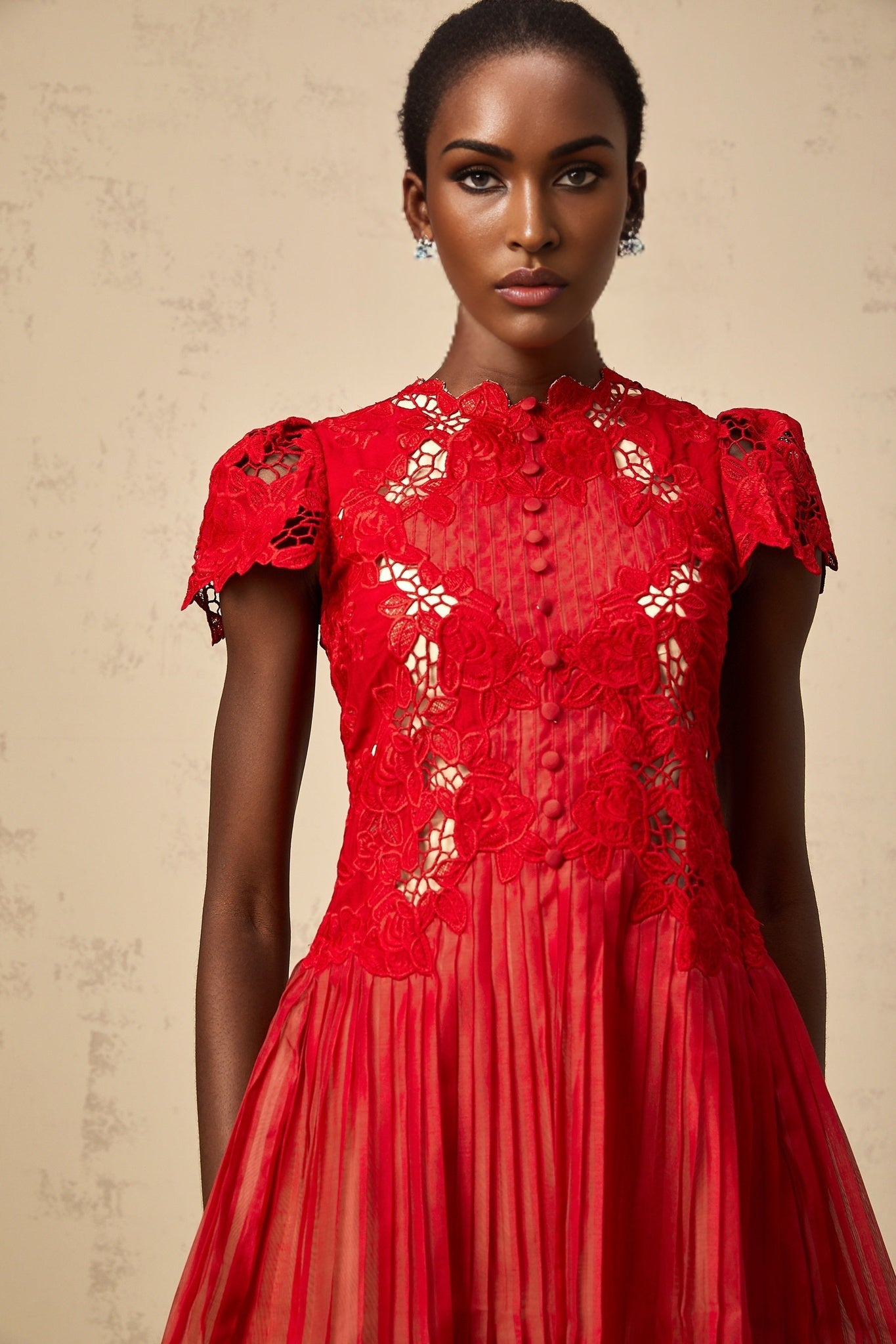 A red mini dress with pleated skirt and floral embroidery details named Corinne