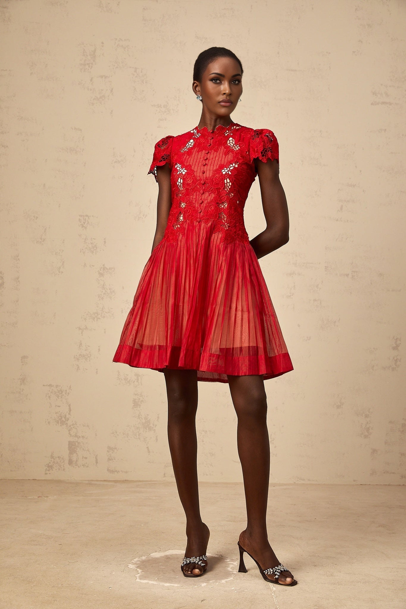 A red mini dress with pleated skirt and floral embroidery details named Corinne