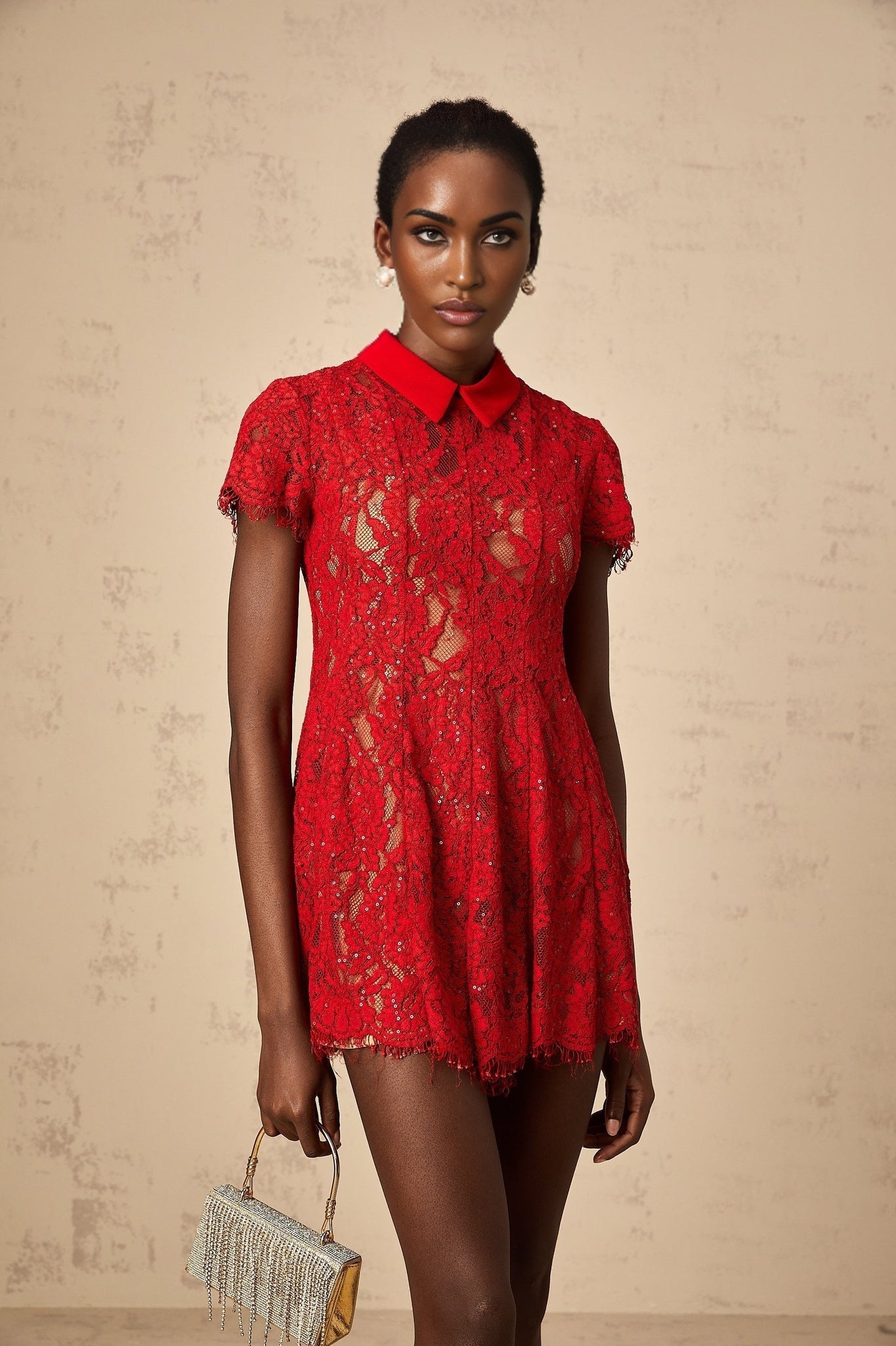 A red mini dress with sequined lace overlay featuring short sleeves and a fitted silhouette