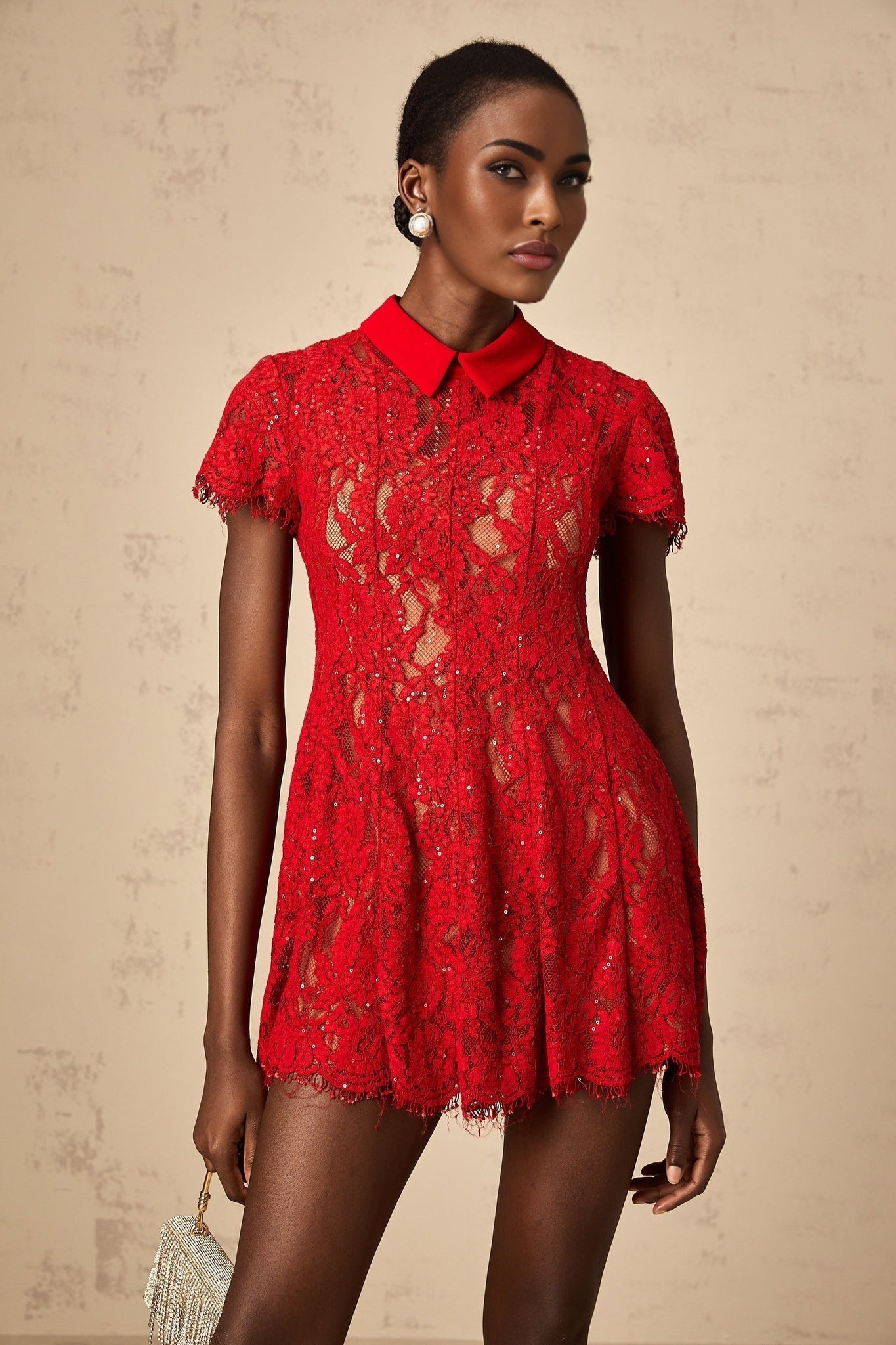 A red mini dress with sequins and lace detailing named Hanne