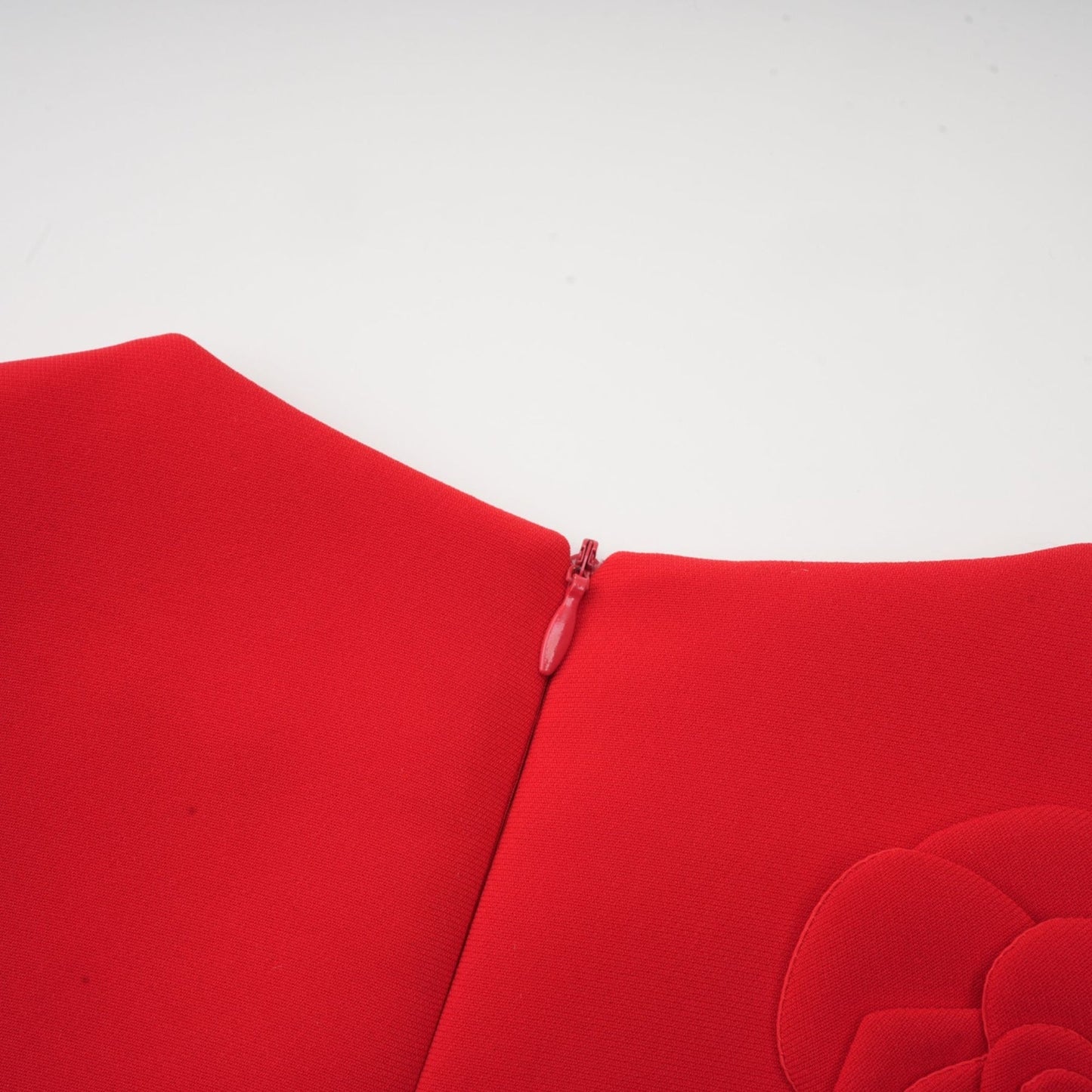 A red mini dress with short sleeves featuring floral details and a feminine silhouette named Calista