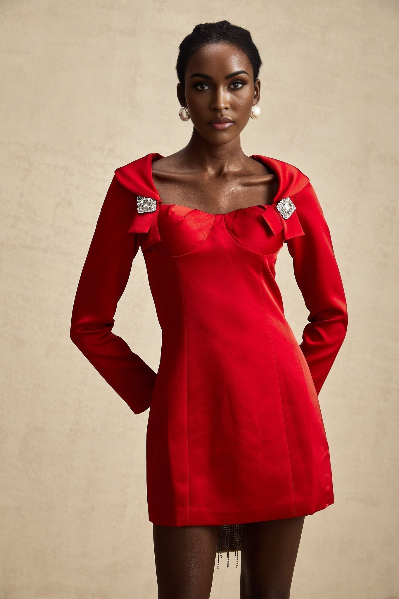 A red satin mini dress by Celine featuring a corset style bodice with a form fitting silhouette and short hemline