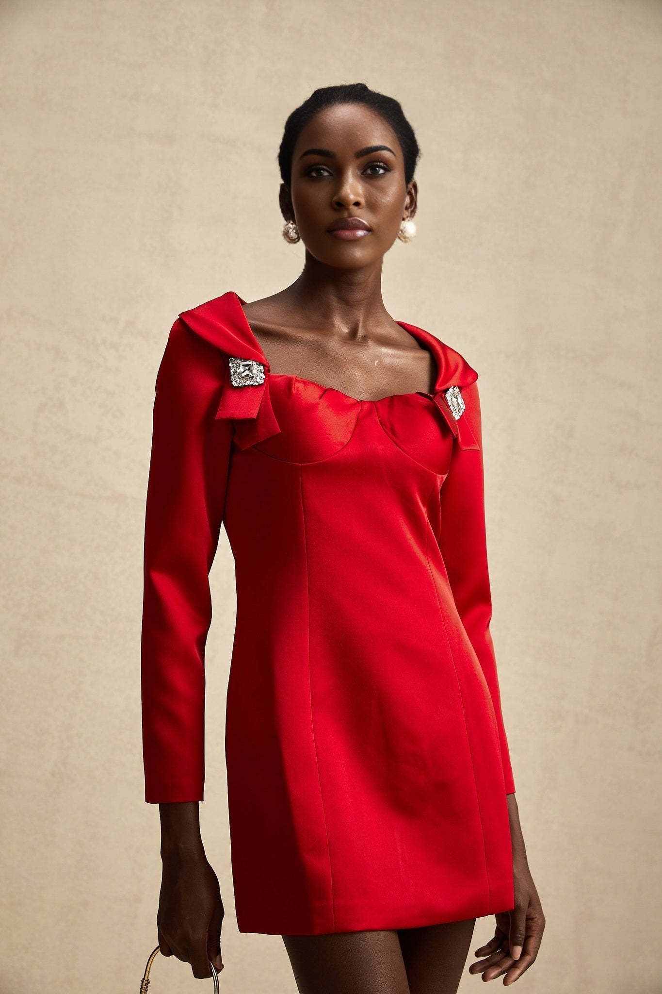A red satin mini dress by Celine featuring a corset style bodice with a short skirt