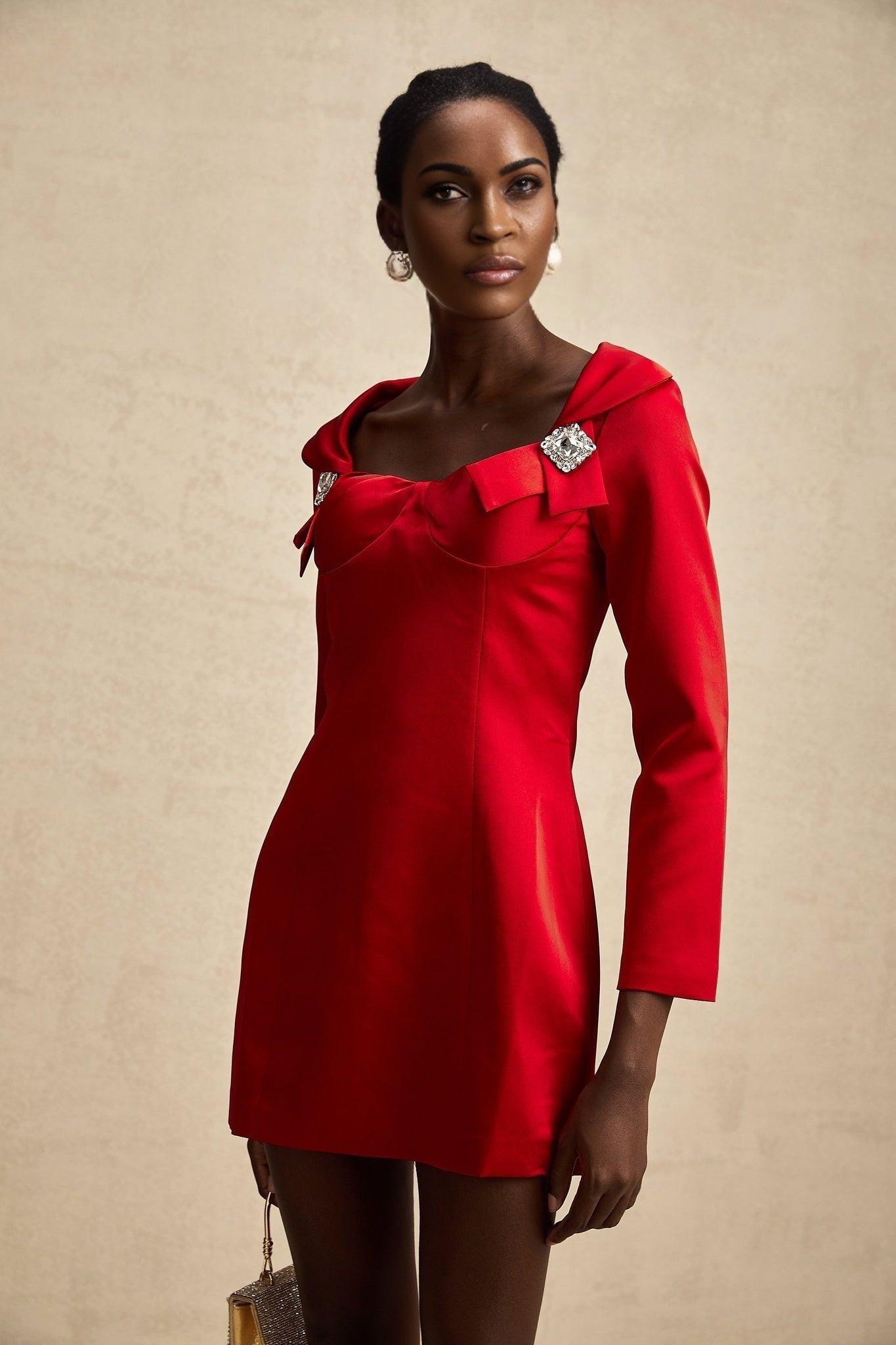 A red satin mini dress by Celine featuring a corset style design with a fitted bodice and short skirt