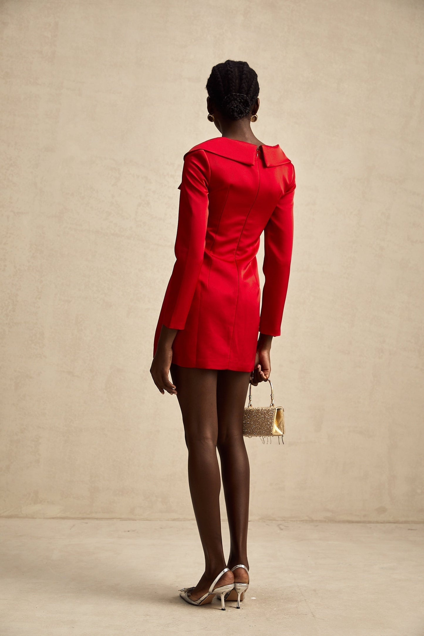 A red satin mini dress by Celine featuring a corset style design