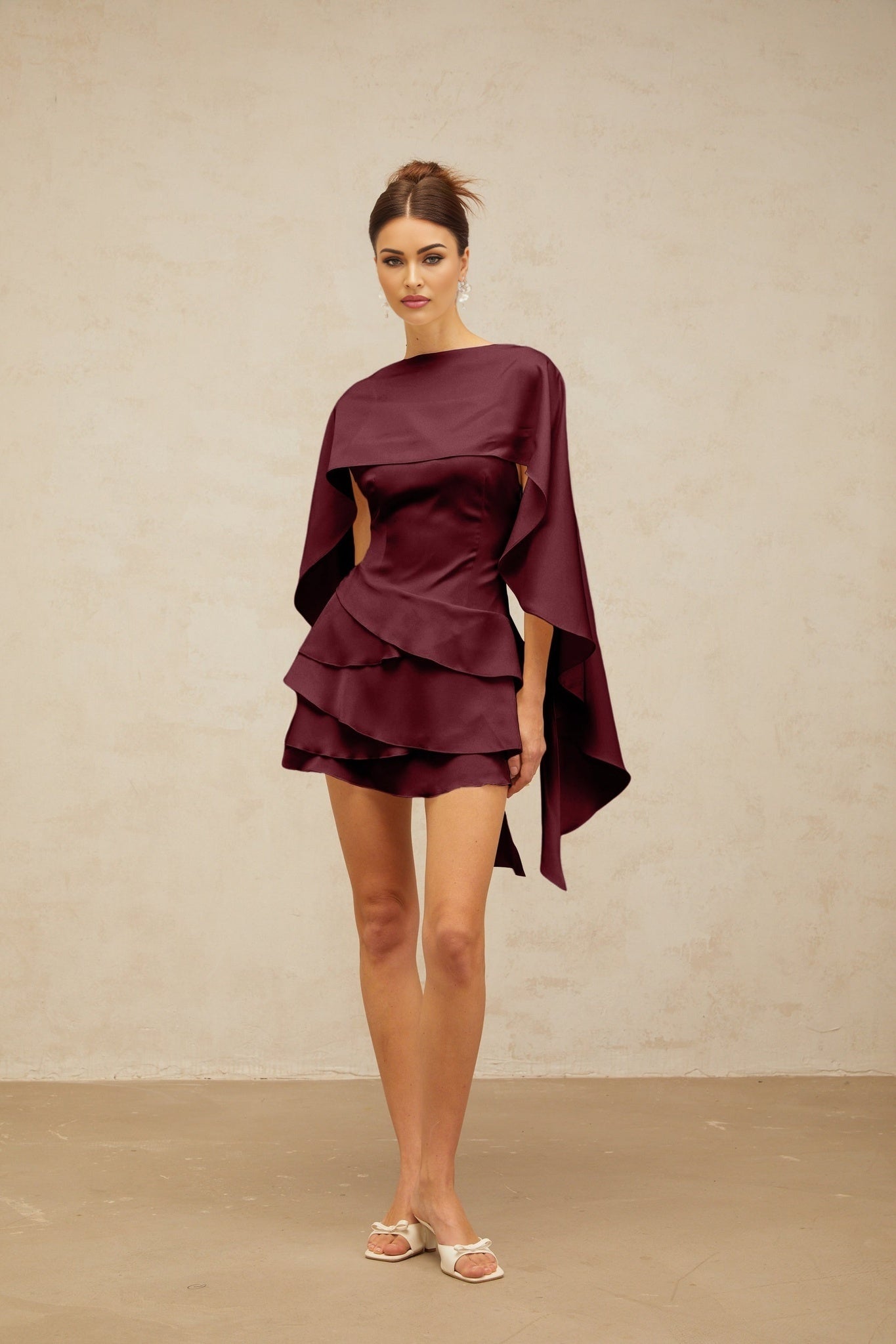 A red satin mini dress with a shawl panel and ruffle details