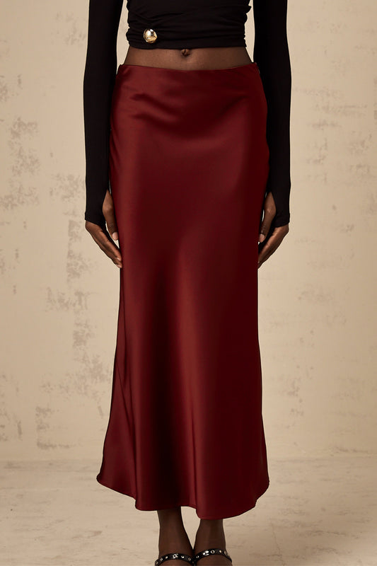 A red satin skirt with a flared silhouette named Vanessa