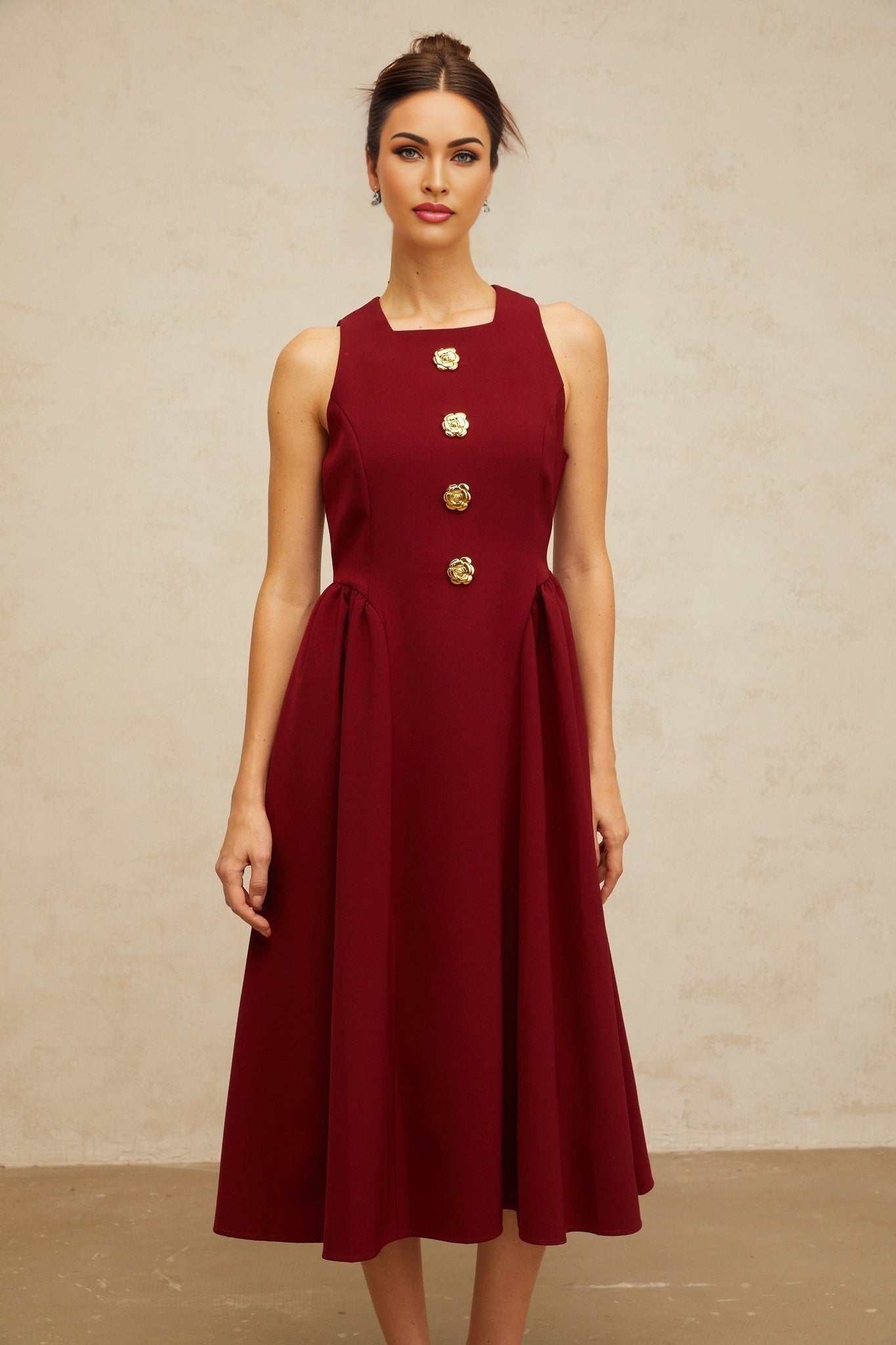 A red sleeveless midi dress with a floral pattern featuring pleats and a tank top style bodice