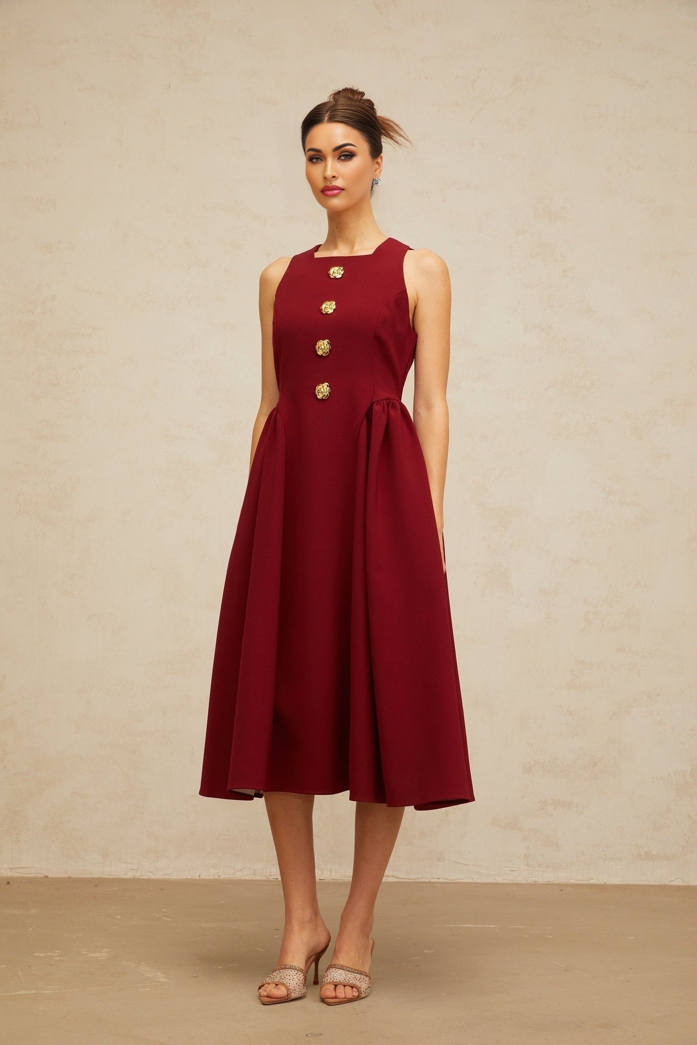 A red sleeveless midi dress with a floral pattern featuring pleats and a tank top style bodice