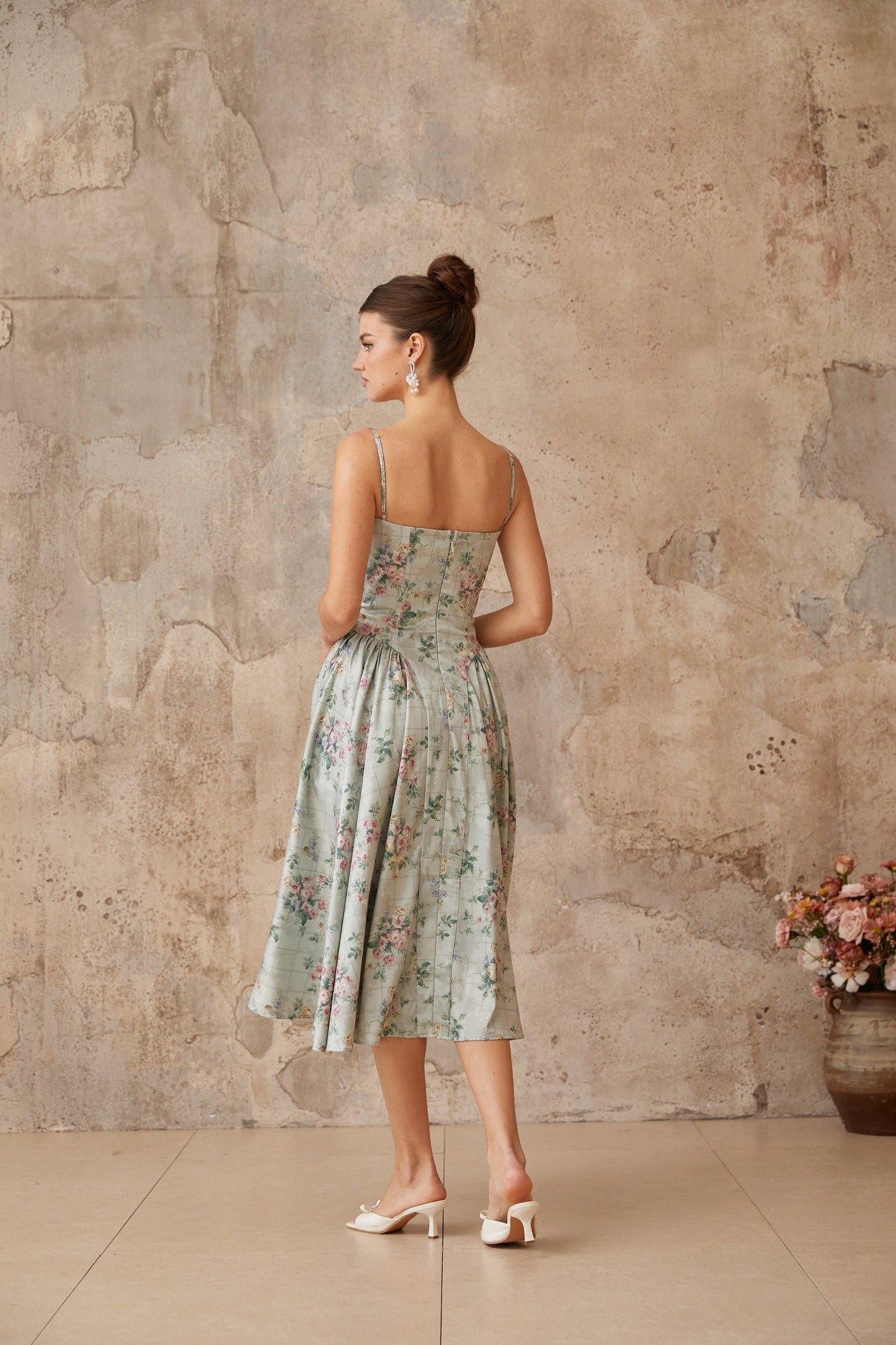 A sagegreen midi dress with a floral print pattern and shirred detailing named Prunelle