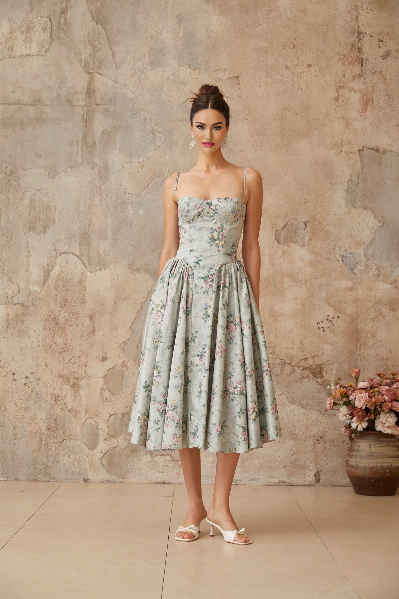 A sagegreen midi dress with a floral print pattern and shirred detailing named Prunelle