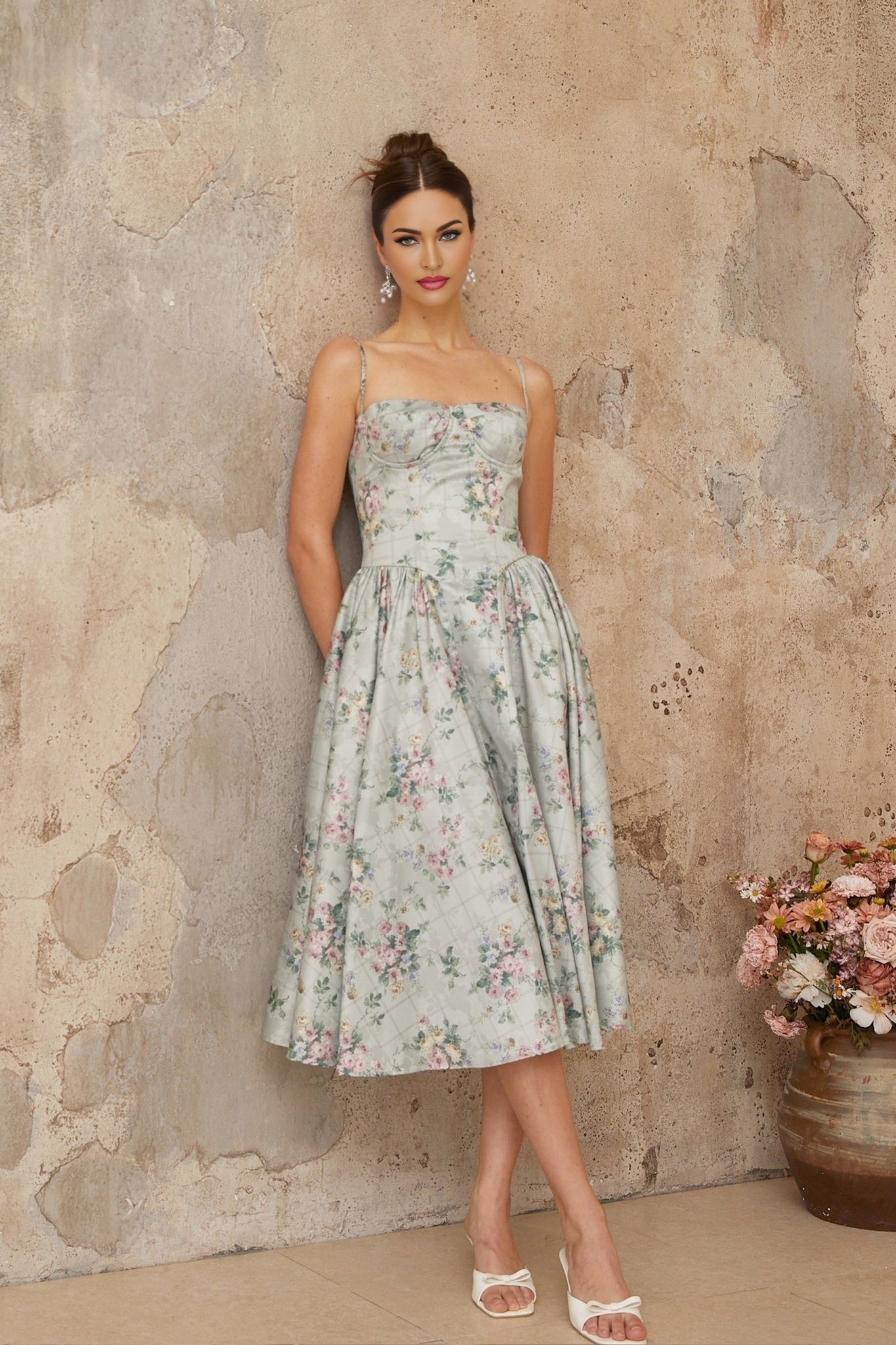 A sagegreen midi dress with a floral print pattern and shirred detailing named Prunelle