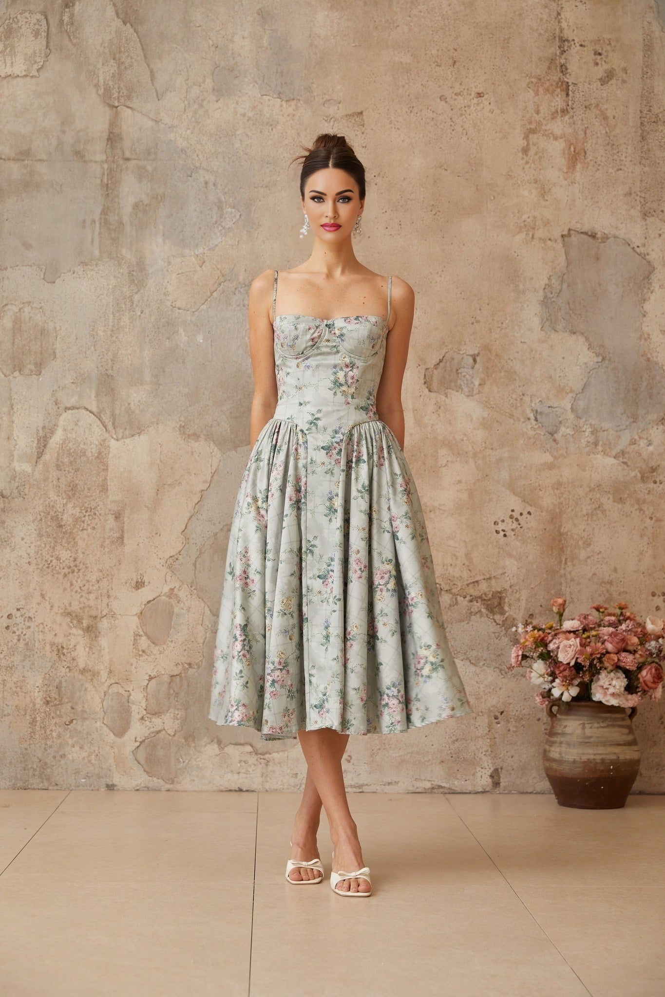 A sagegreen midi dress with a floral print pattern and shirred details named Prunelle