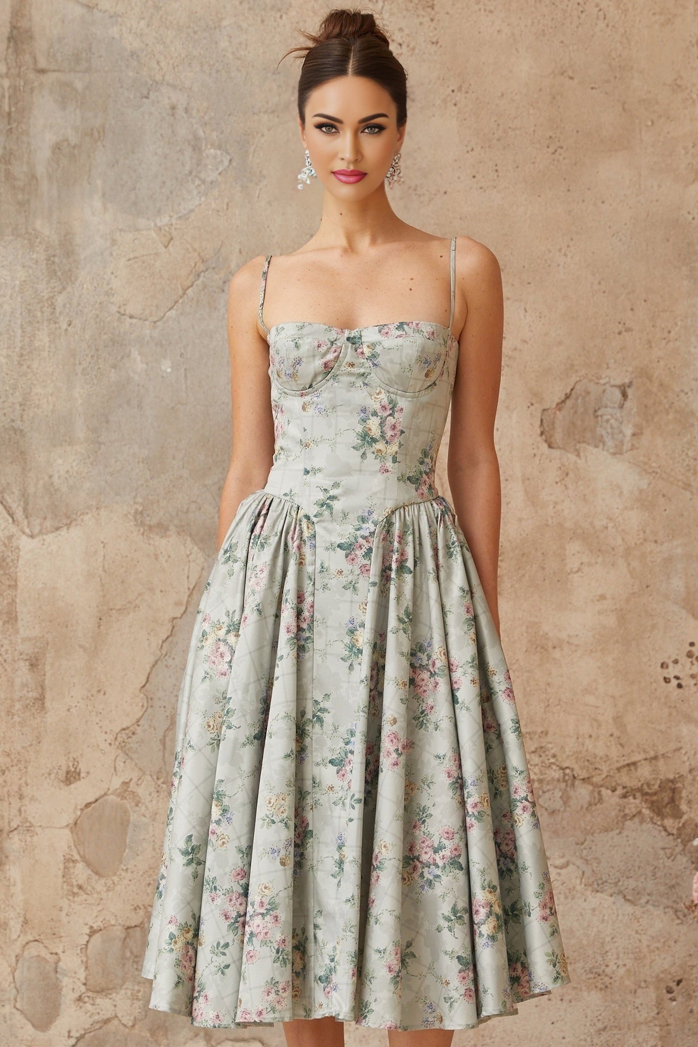 A sagegreen midi dress with a floral print pattern featuring shirred detailing and a feminine silhouette