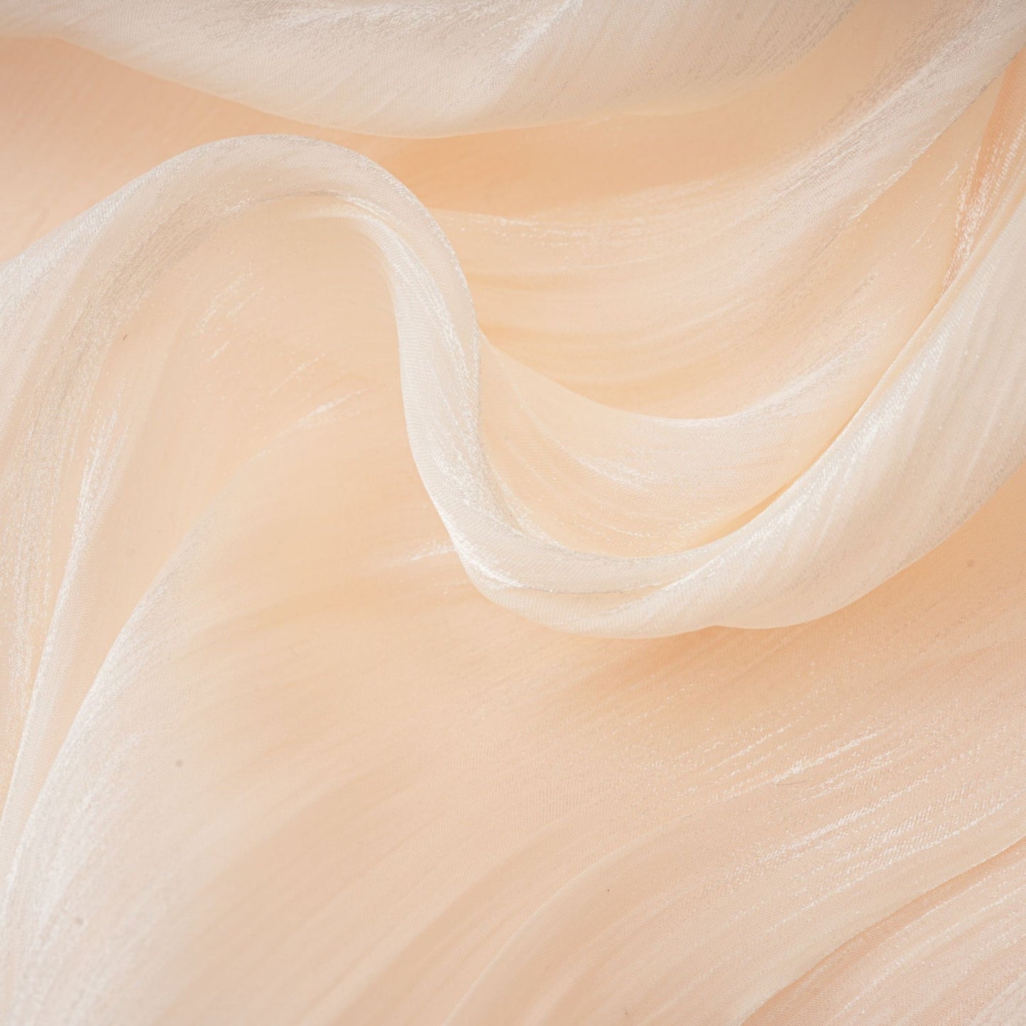 A short beige mini dress with full pleats and ruffles throughout featuring a flowy silhouette and feminine details