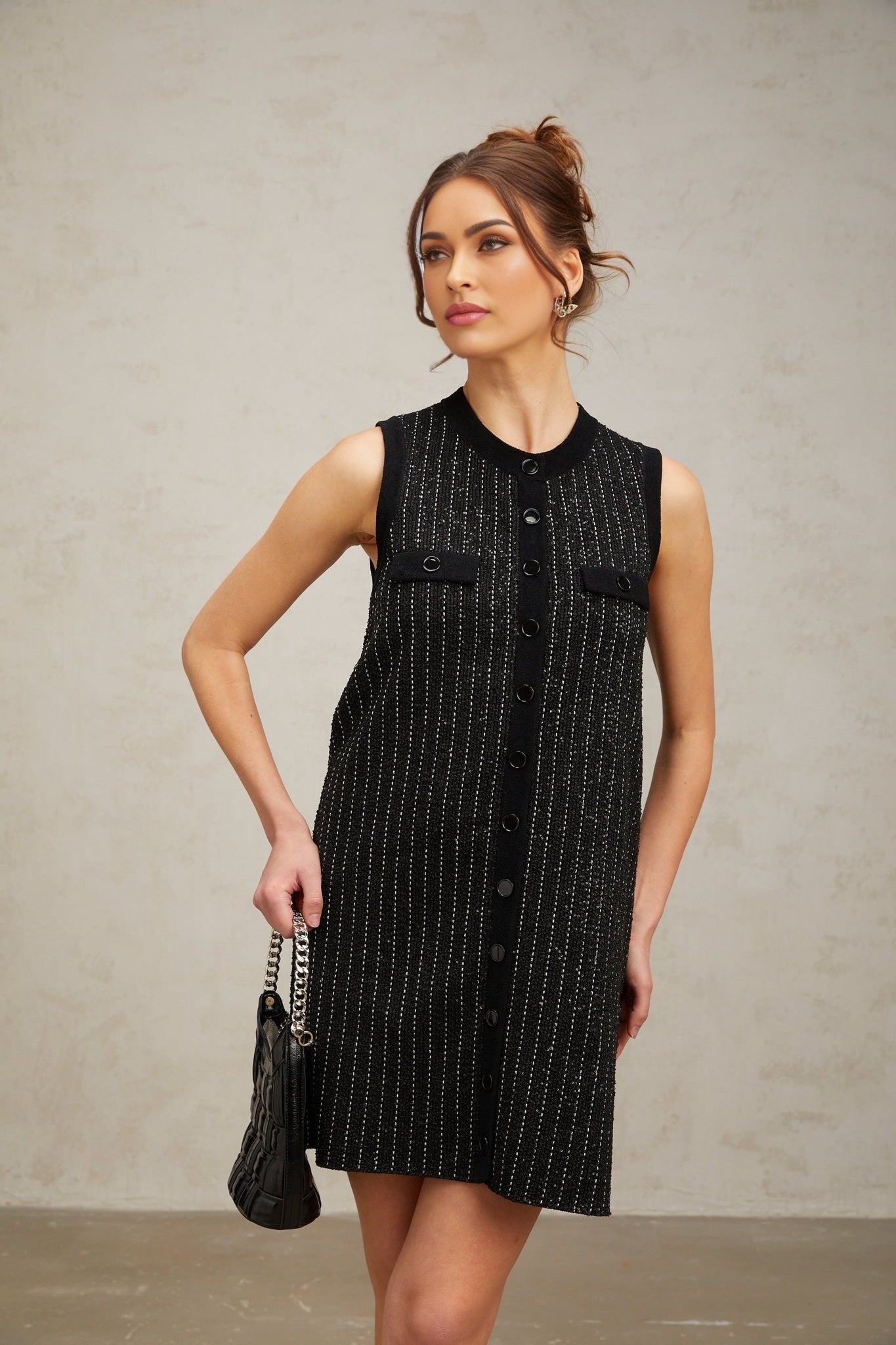 A short black knit mini dress with vertical stripes and sequin embellishments inspired by Zelda style