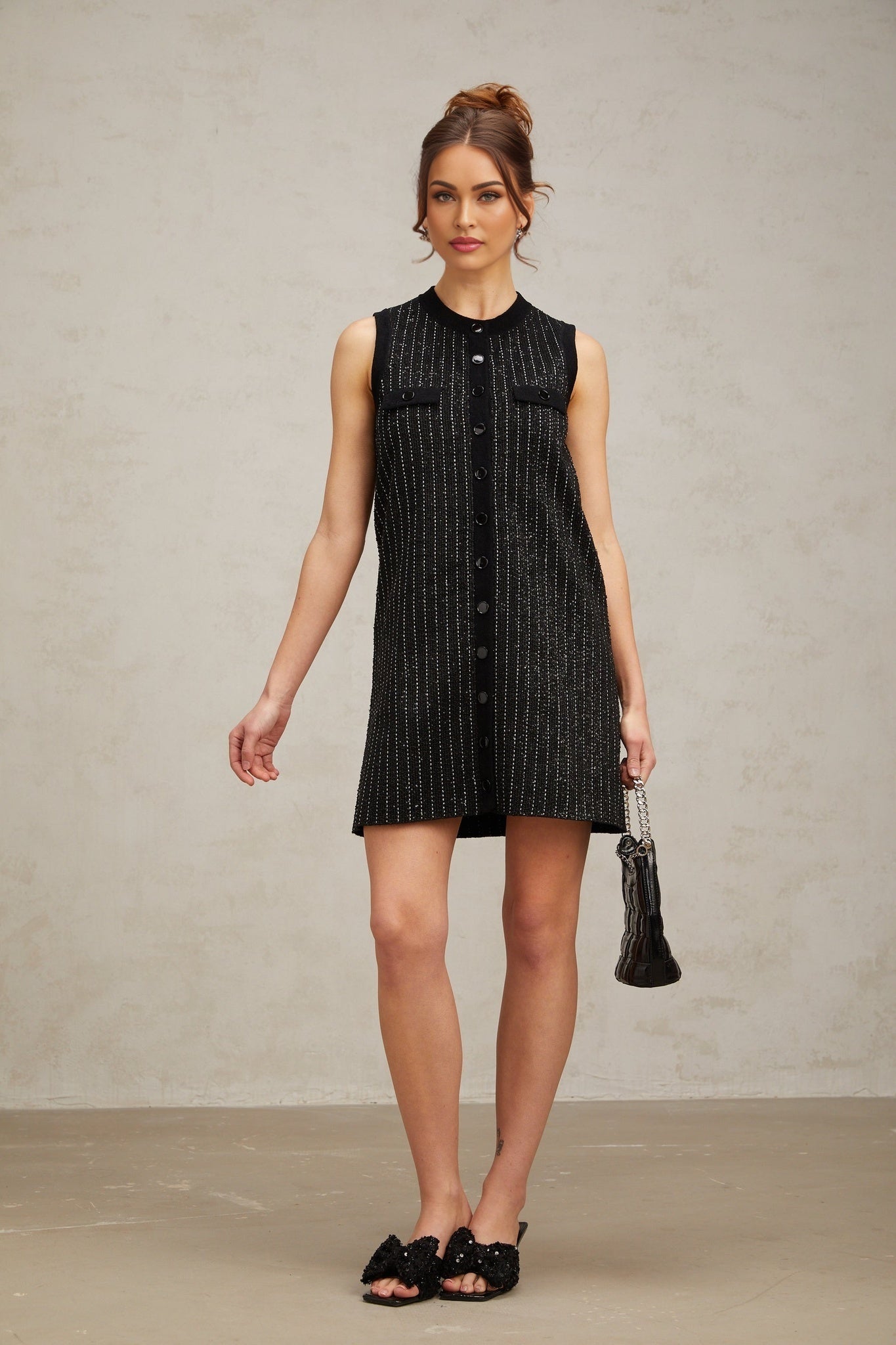 A short black knit mini dress with vertical stripes made of sequins featuring a Zelda design