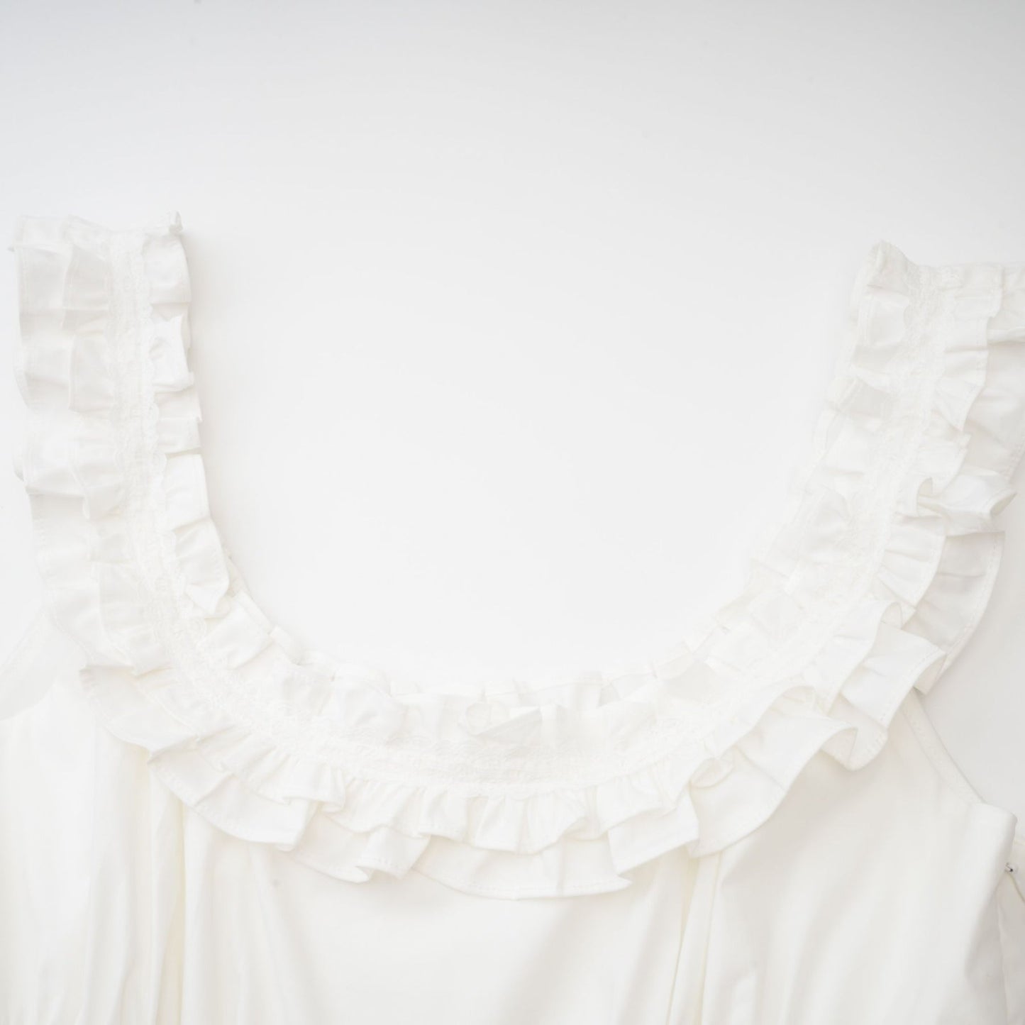 White Uneck sleeveless dress with ruffled and crystal embellished detailing pleats rear zip mini length 100% Cotton