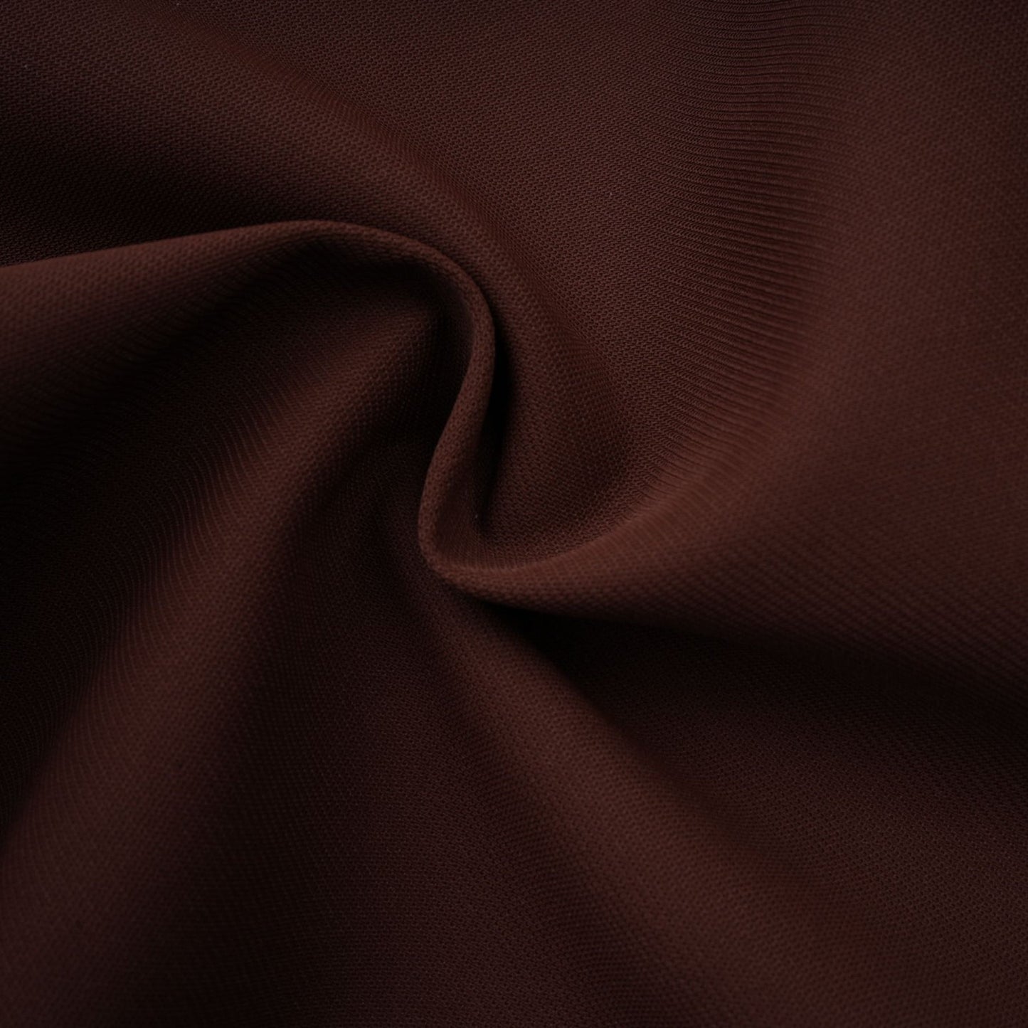 A short brown dress with an asymmetric neckline and puff sleeves in a mini length style called Dora