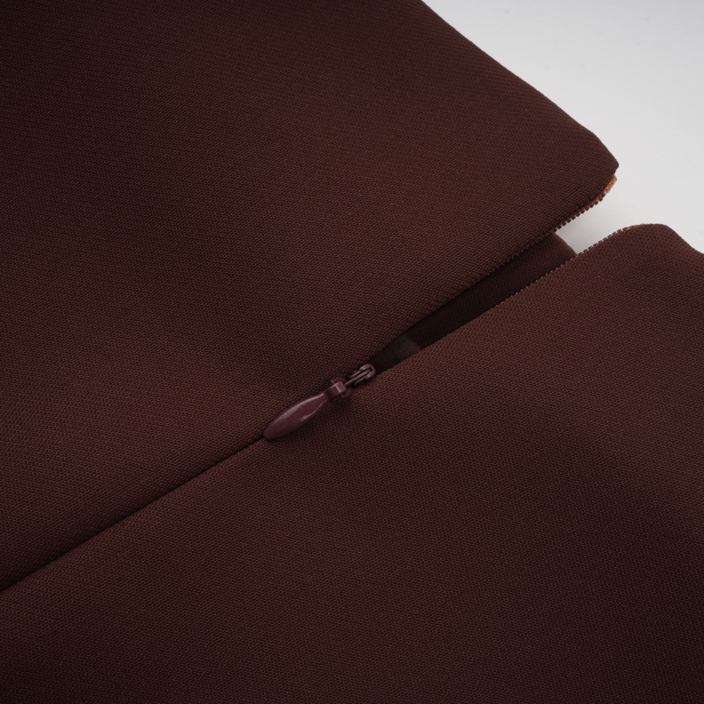 A short brown dress with an asymmetric neckline and puff sleeves in a mini length style named Dora